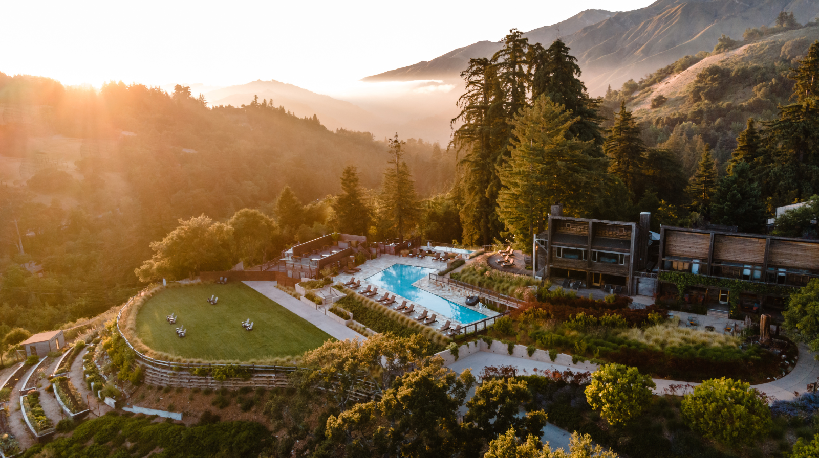 Alila Ventana Big Sur luxury resort pool overlooking Pacific Ocean mountains at sunset in California