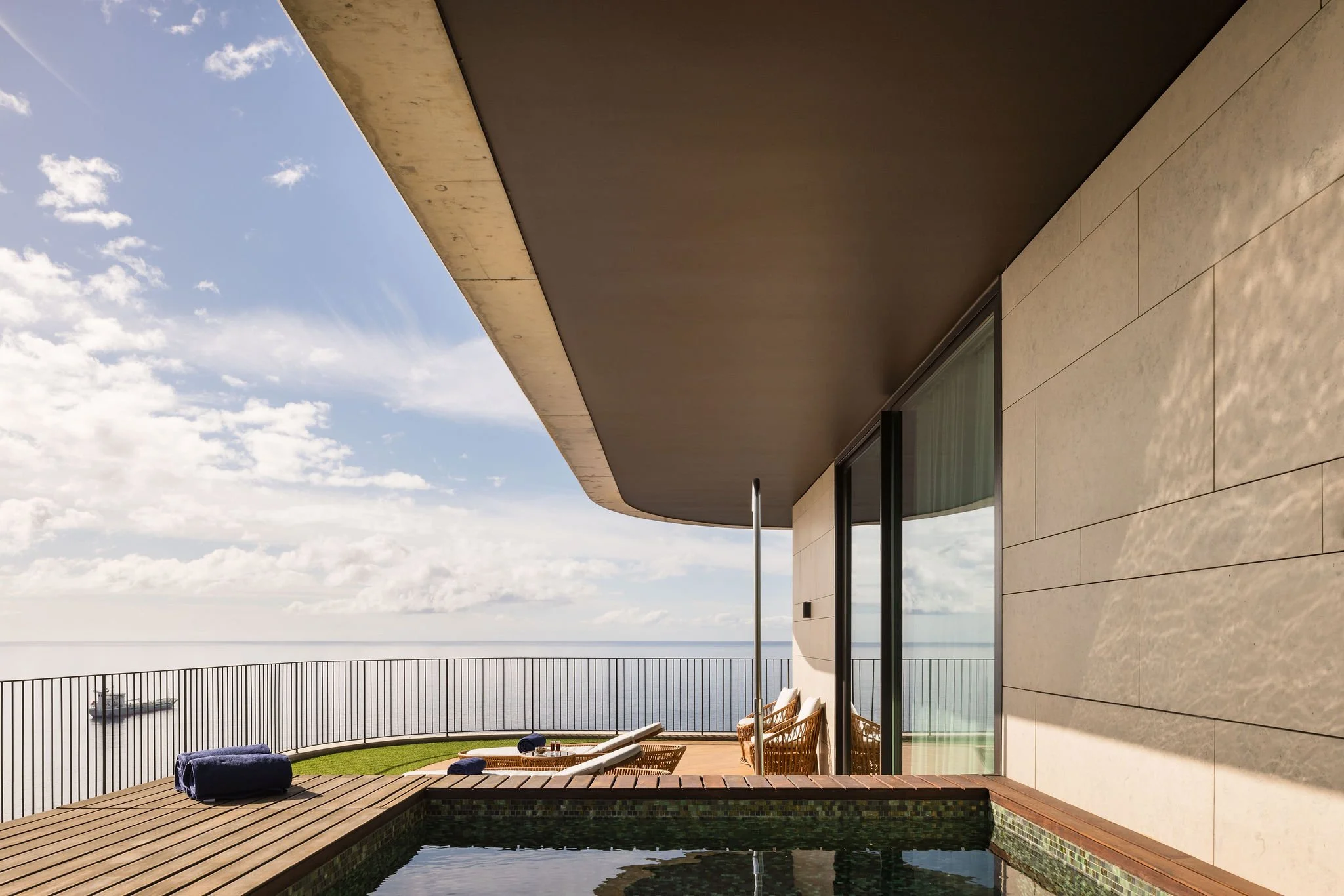 Private corner suite terrace with a small pool, modern architecture, ocean views, and minimalist outdoor furniture—design-forward, uncluttered, and serene.