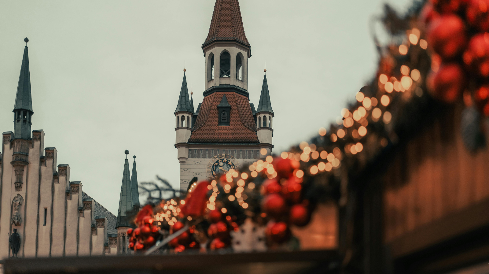 Munich Christmas market with decorated stalls and Old Town Hall tower at Marienplatz, Germany