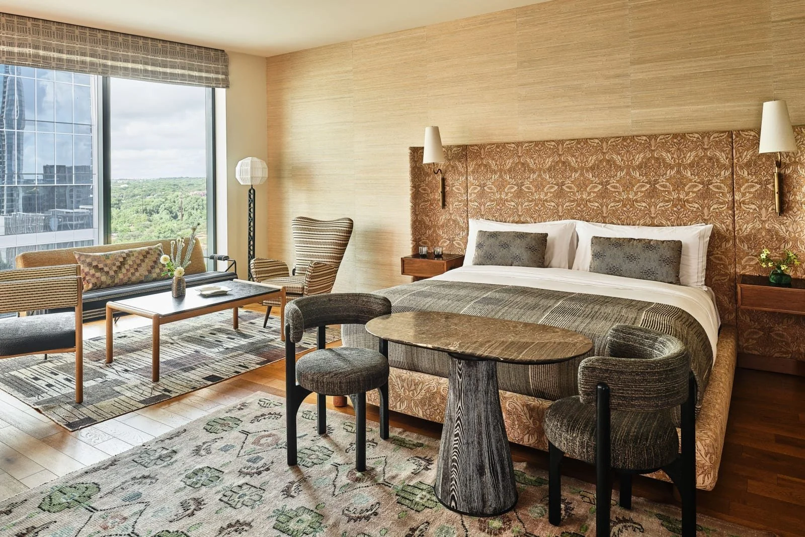 Modern guest room at Austin Proper Hotel in Austin, Texas, featuring floor-to-ceiling windows, city views, and stylish furnishings—perfect for travelers seeking luxury accommodations in downtown Austin.