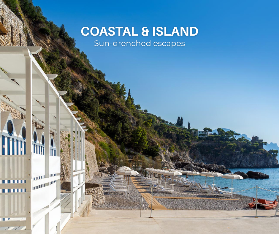 Private beach at Borgo Santandrea hotel on the Amalfi Coast, featuring striped cabanas, sun loungers, umbrellas, and stunning coastal views.