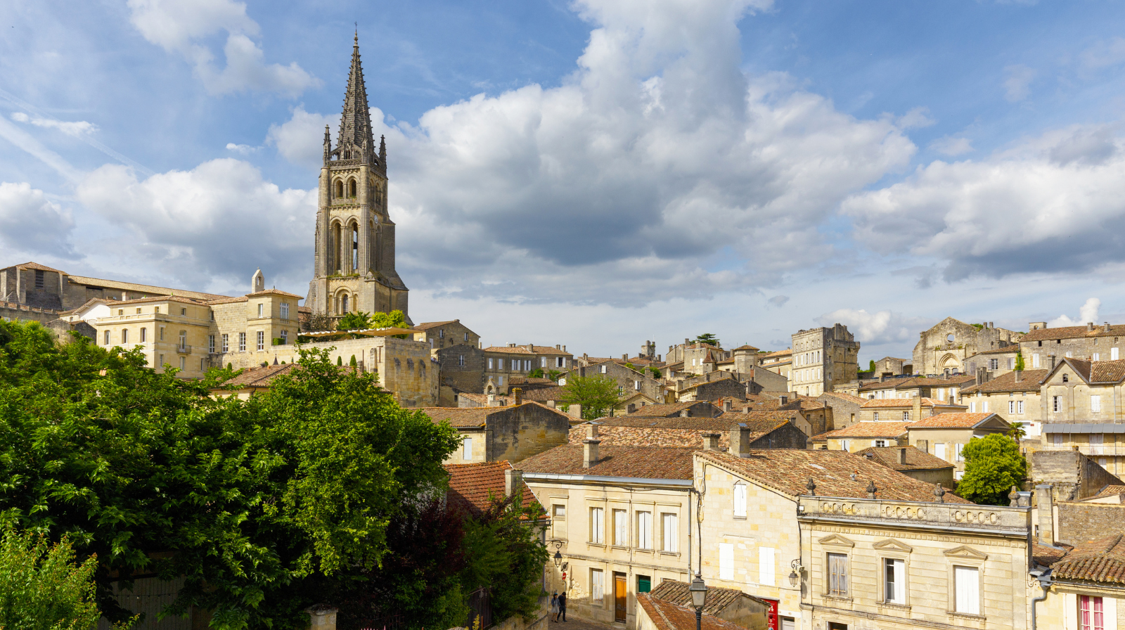 Historic limestone buildings and church tower in Saint-Émilion medieval village, Bordeaux wine region