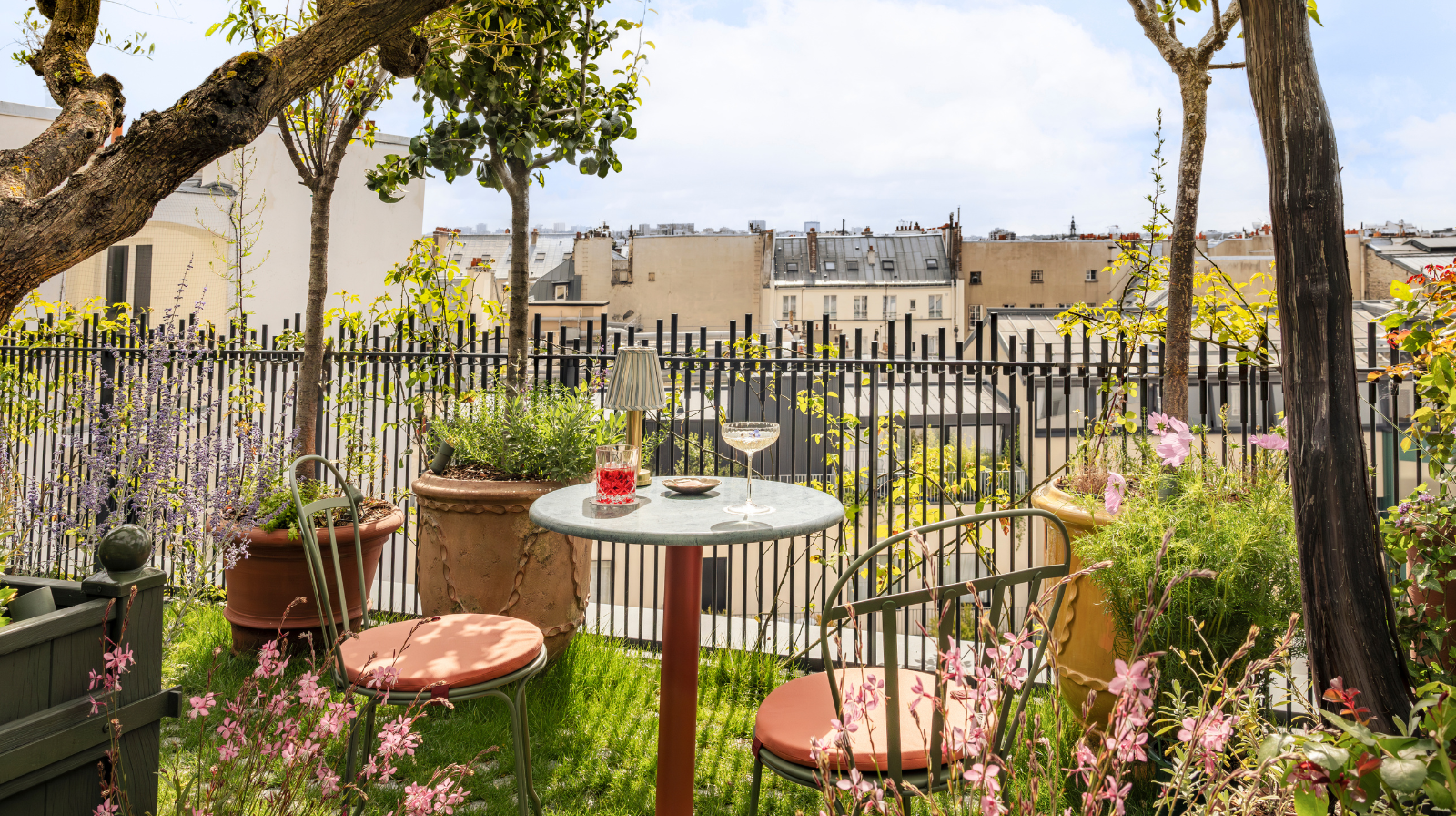 Private rooftop garden terrace overlooking Parisian buildings at boutique hotel La Fantaisie