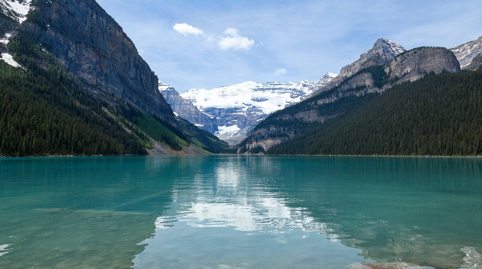 Turquoise glacial Lake Louise surrounded by snow-capped mountains in Banff National Park, Alberta, Canada