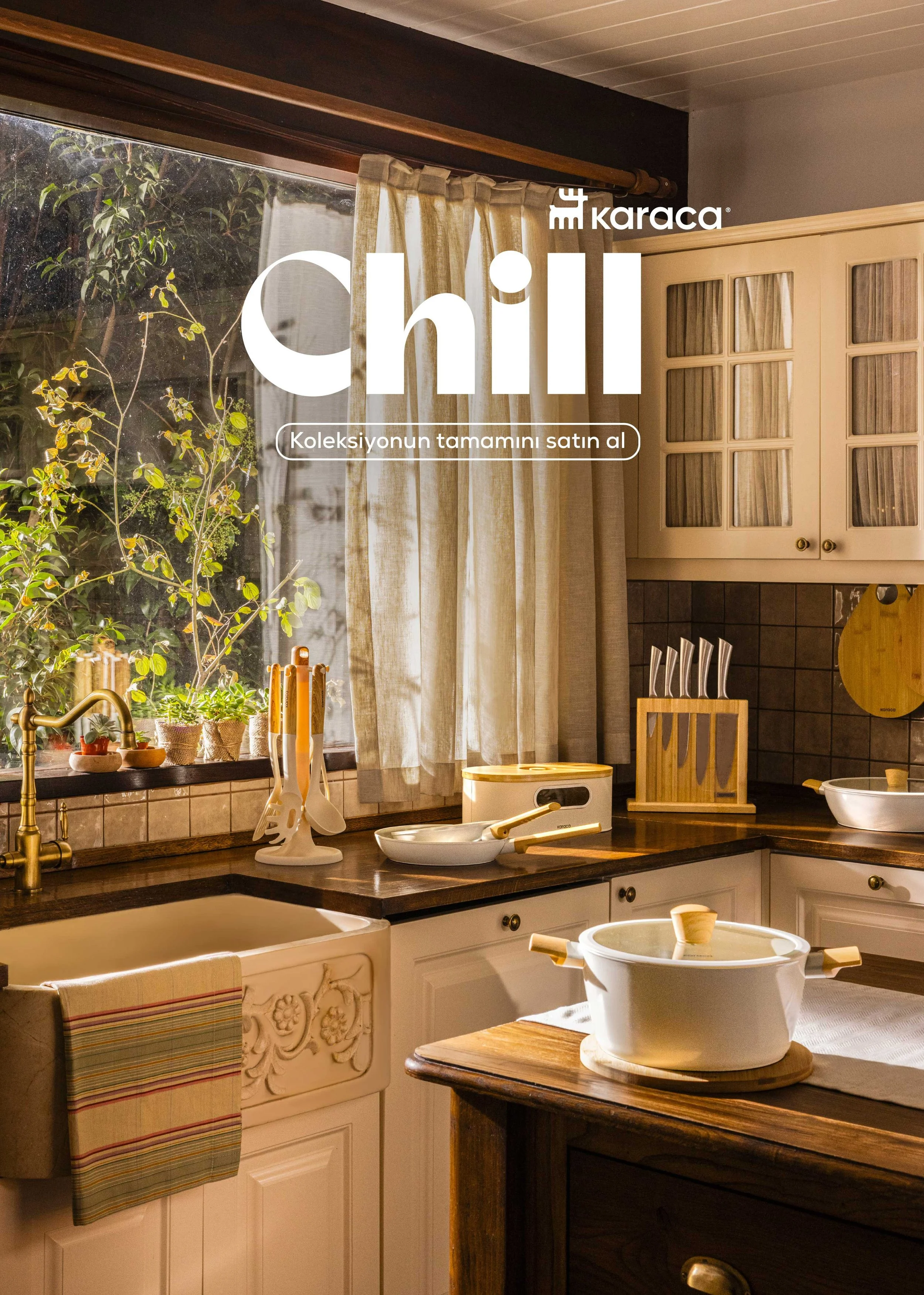 A cozy kitchen with sunlight coming through a window with cream curtains, wooden cabinets with glass doors, and various kitchen utensils and plants on the countertop.