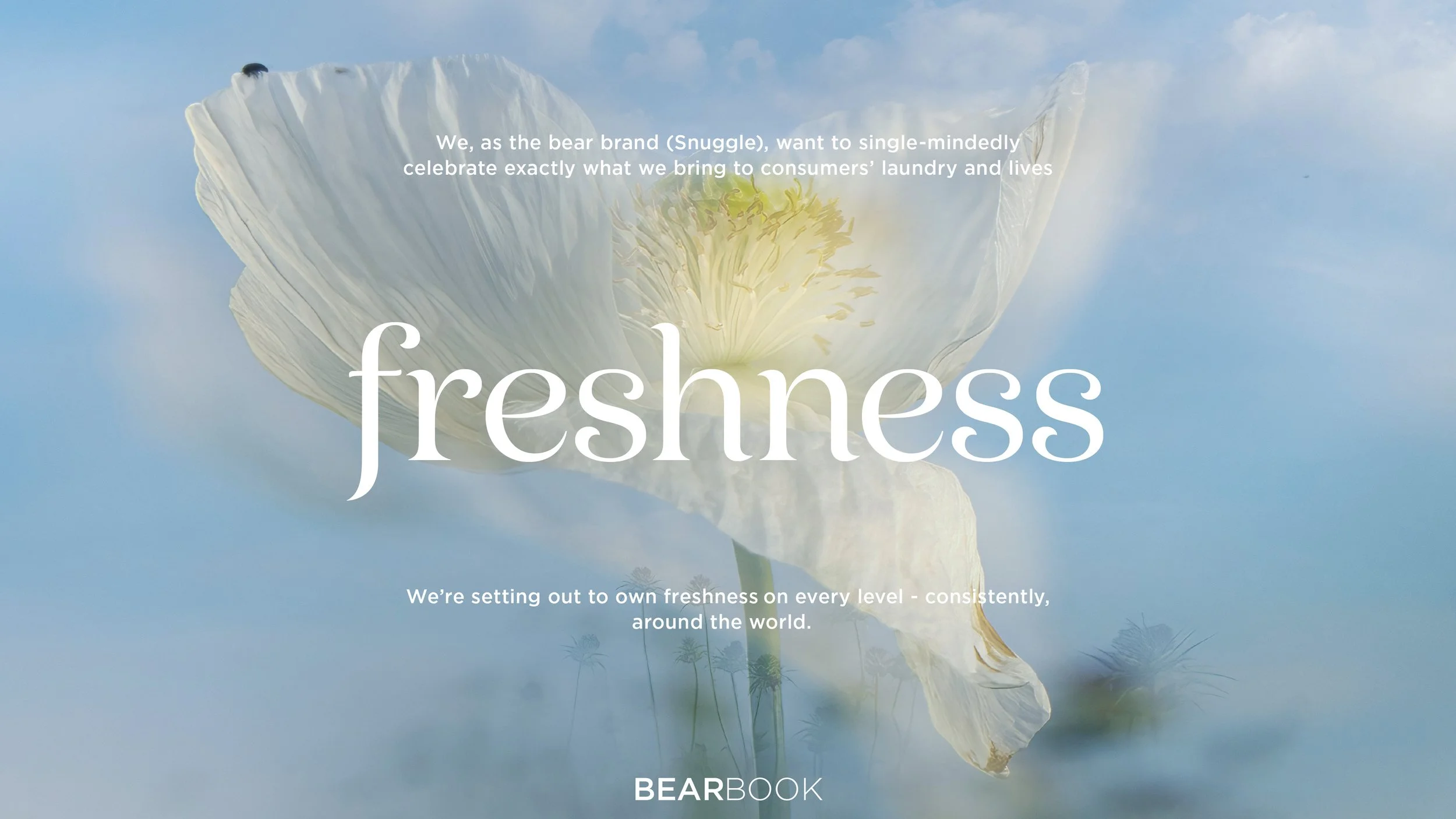 A close-up of a white poppy flower against a cloudy sky with the word 'freshness' overlaid in large text and additional text about the brand 'Snuggle' and setting out to own freshness around the world.