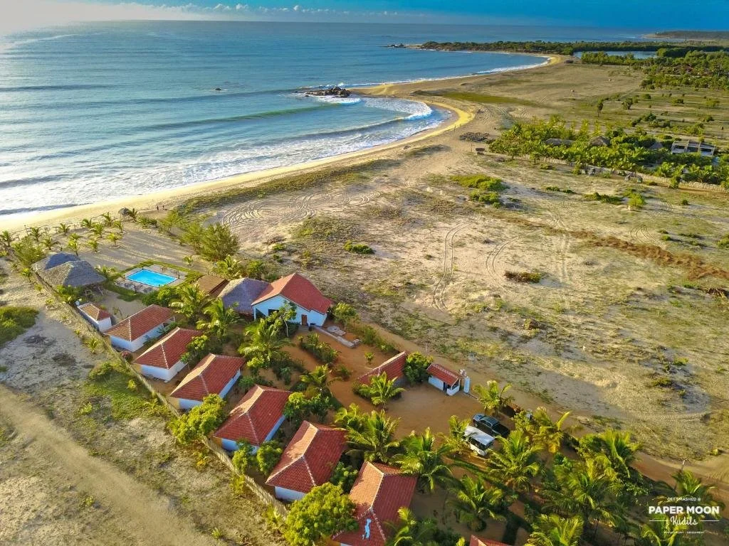Aerial view of Paper Moon Kudils and the coastline near Arugam Bay