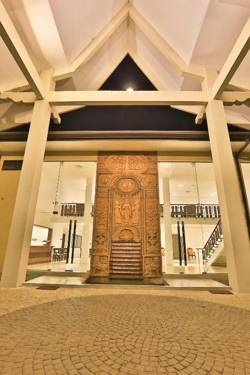 Entrance hall with traditional carved doors at Rajarata Hotel in Anuradhapura