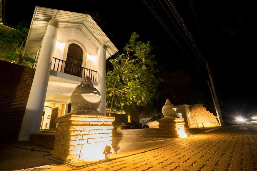 Illuminated entrance and traditional architecture at Hotel Alakamanda in Anuradhapura