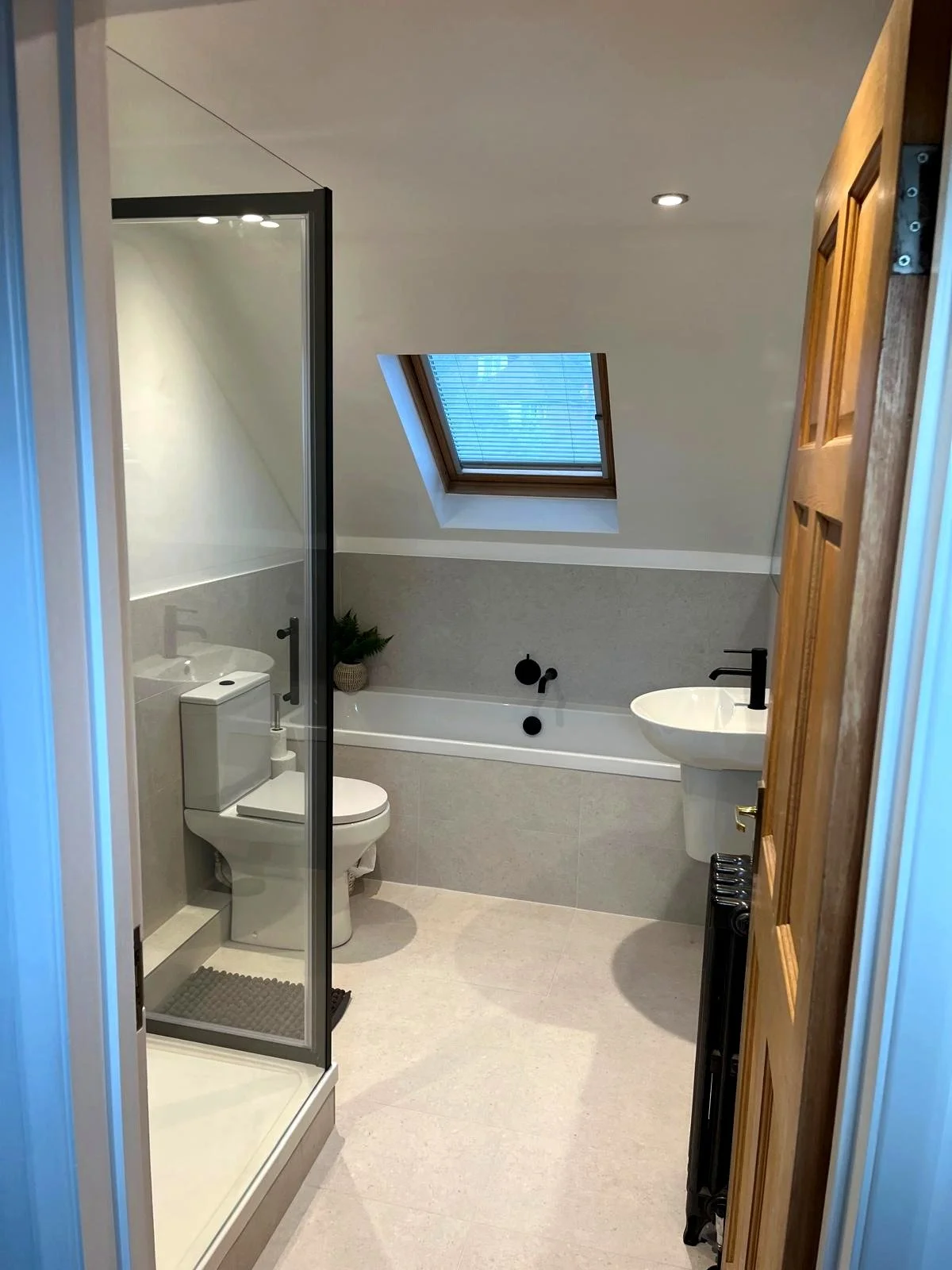 Finished bathroom with bath, shower and basin installed in a Brighton home