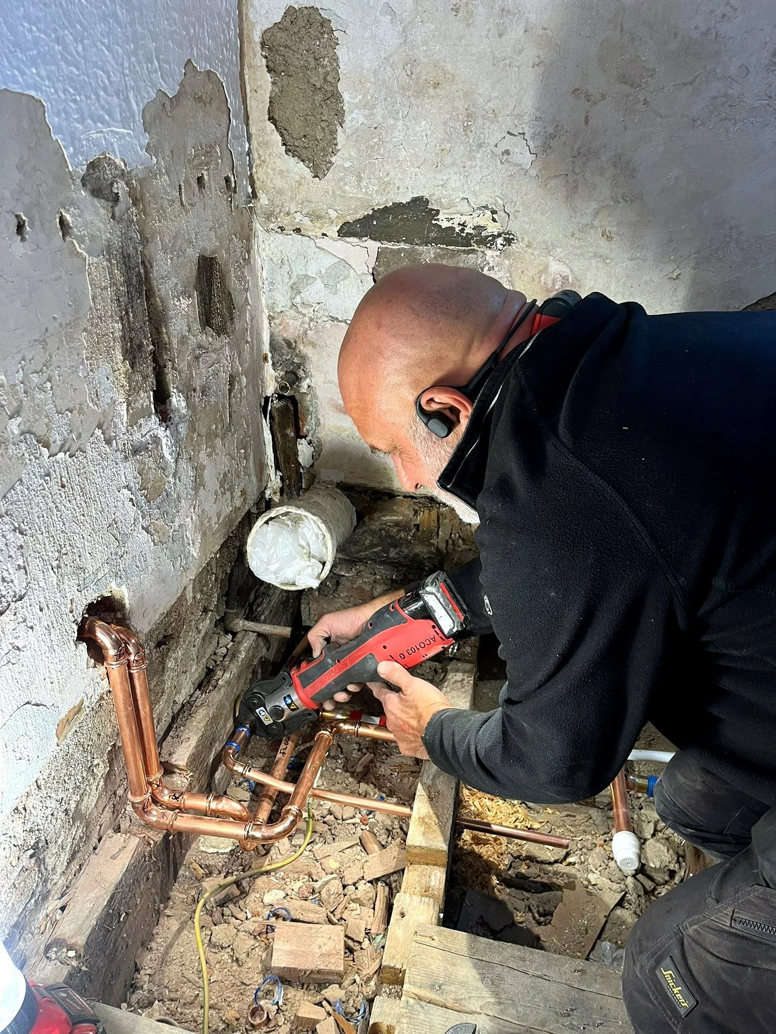 Matt Cassar fitting copper pipework during a plumbing and heating installation.