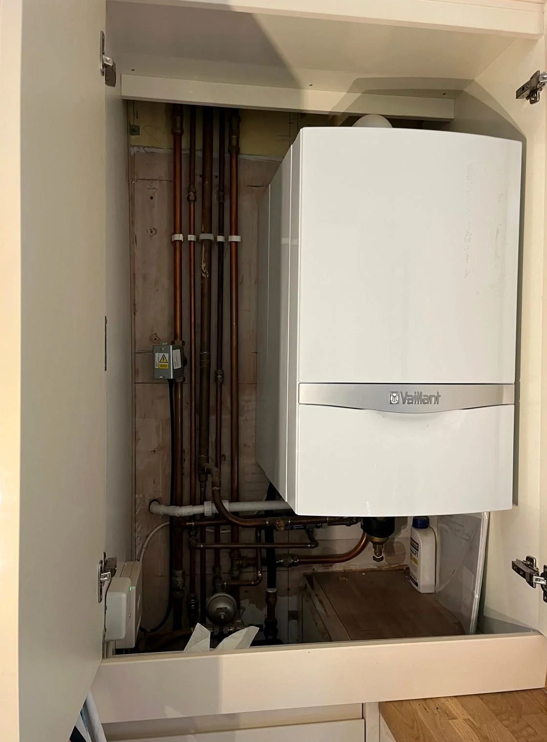 Vaillant boiler installation neatly fitted inside a kitchen cupboard with tidy copper pipework