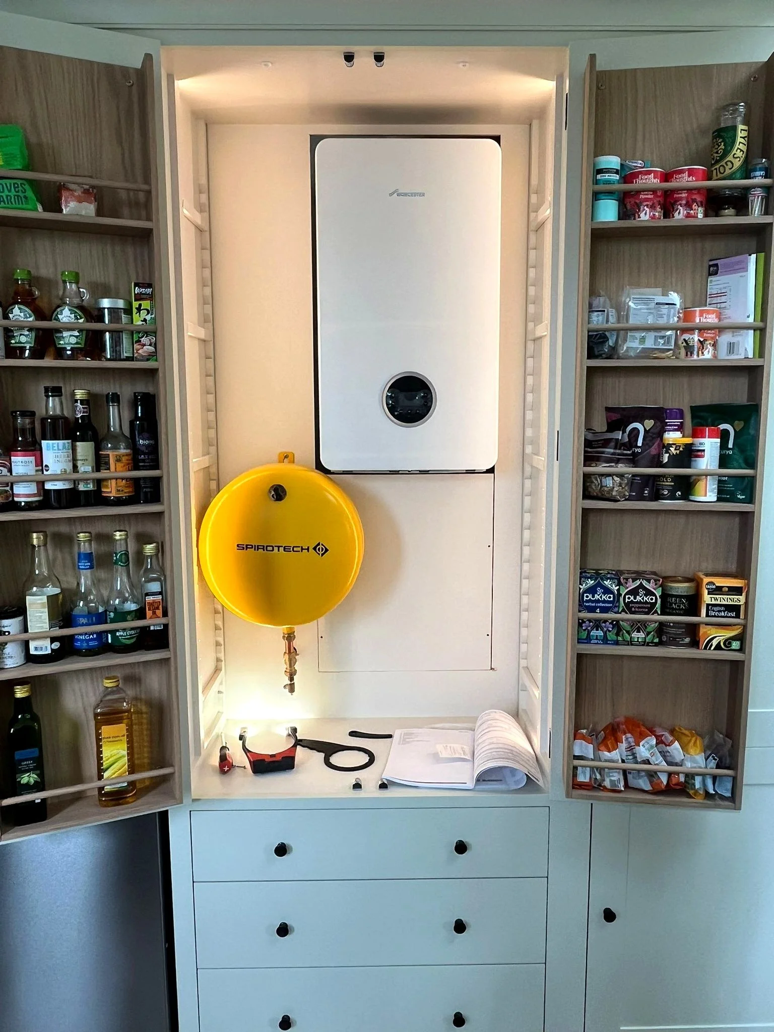 Neatly installed boiler inside a fitted cupboard in a Brighton home