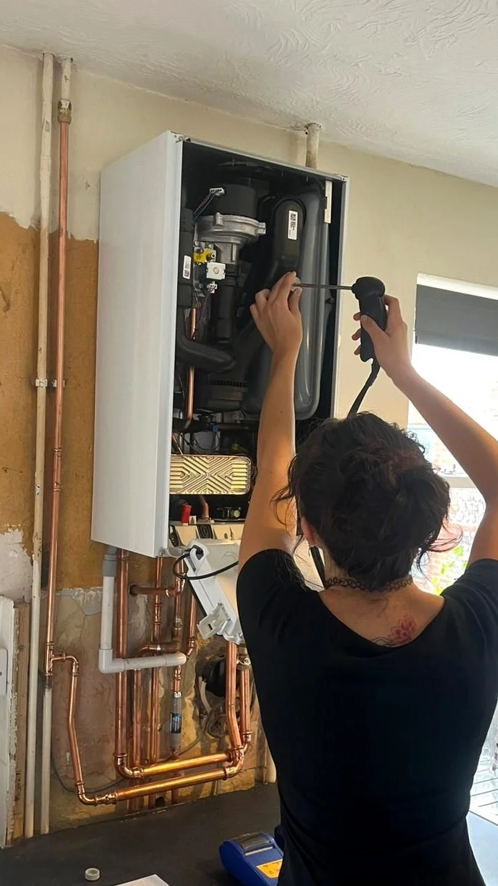 Boiler servicing being carried out on an open boiler in a Brighton home