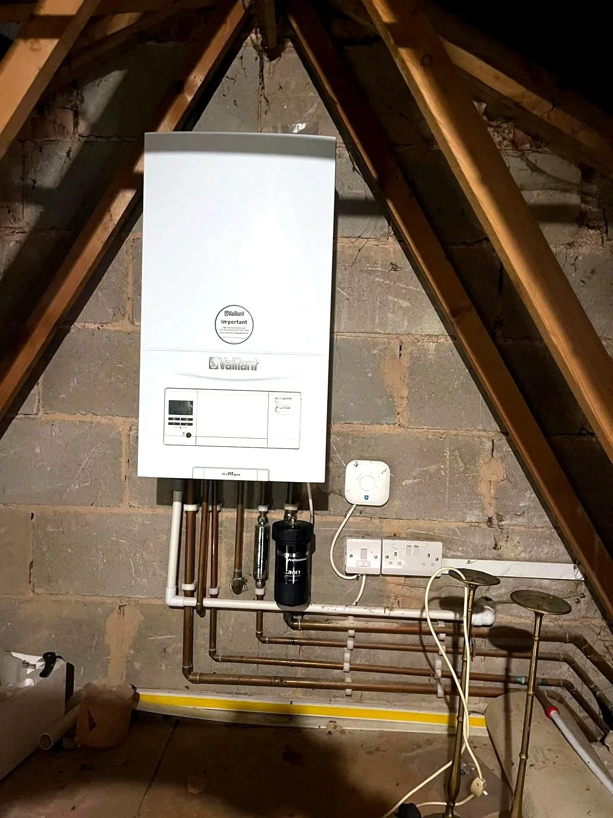 Vaillant boiler installation with tidy pipework mounted in a loft space.