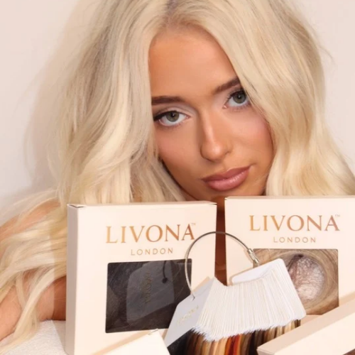 Blonde model wearing LIVONA LONDON hair, behind four livona london boxes and a colour swatch ring resting on a desk