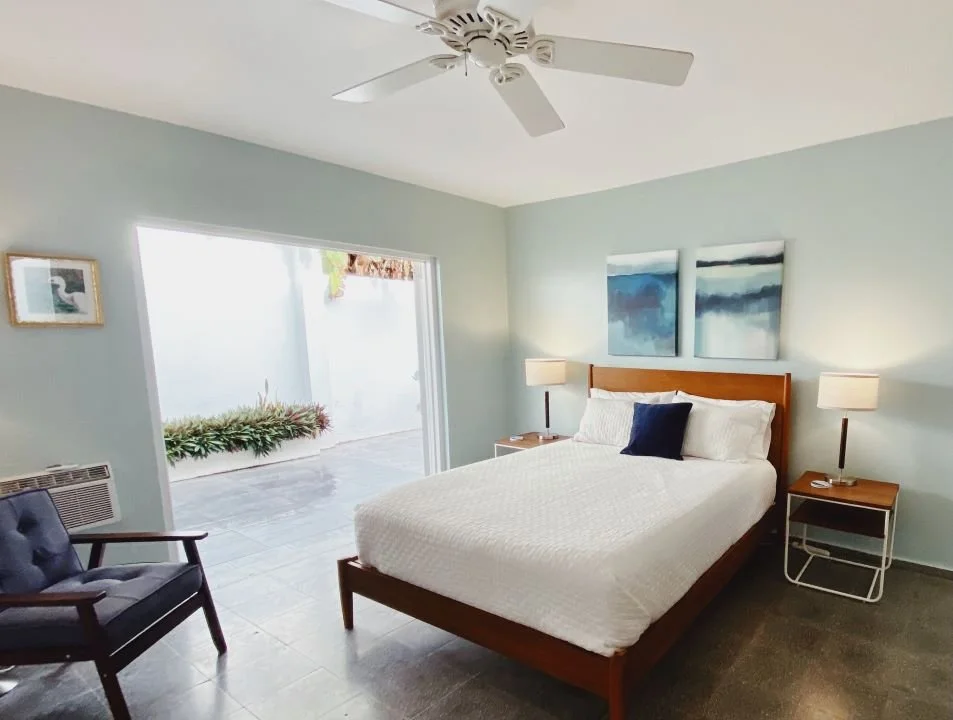 Main bedroom with a Queen bed and french doors leading to the garden terrace.