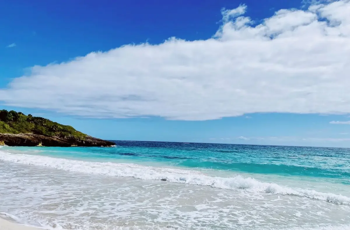 Playa La Chiva with white sand, turquoise water.