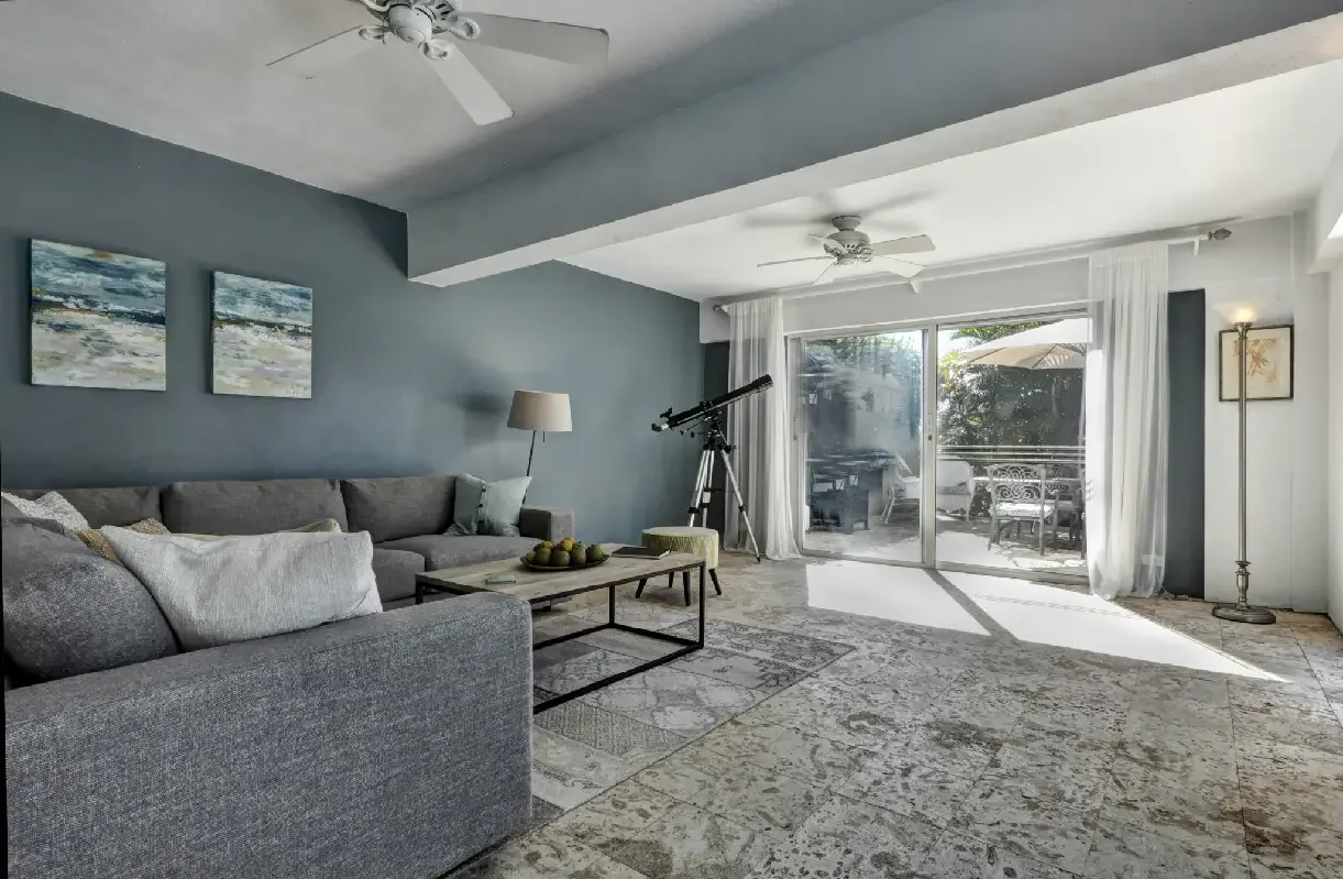 Living room sliding glass doors leading to outdoor dining area.