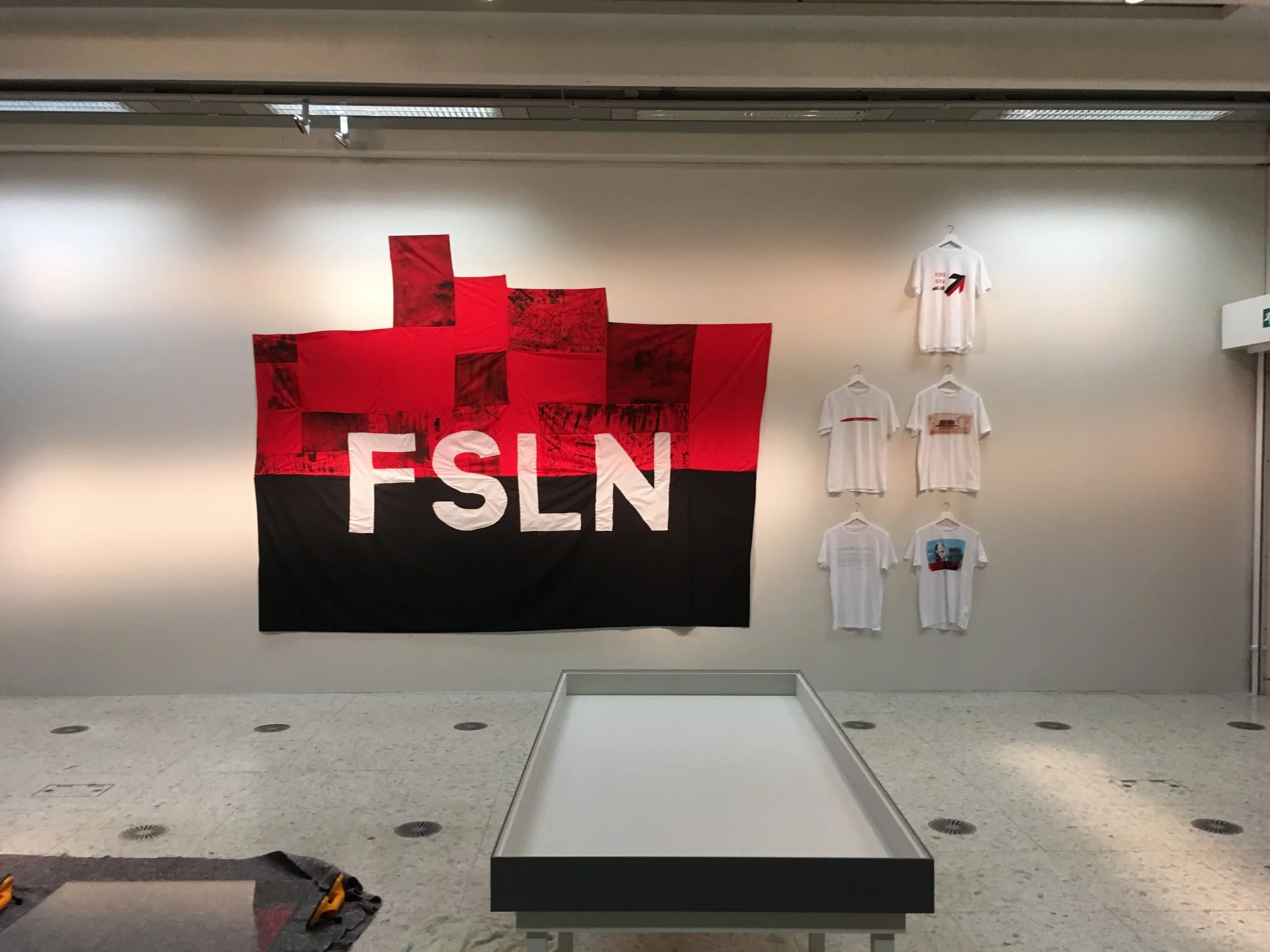 Something & Nothing 2019.  exhibition view. T-shirts, screenprinted, textile flag. Coventry Biennial commission, the Herbert Art Gallery & Museum, Coventry