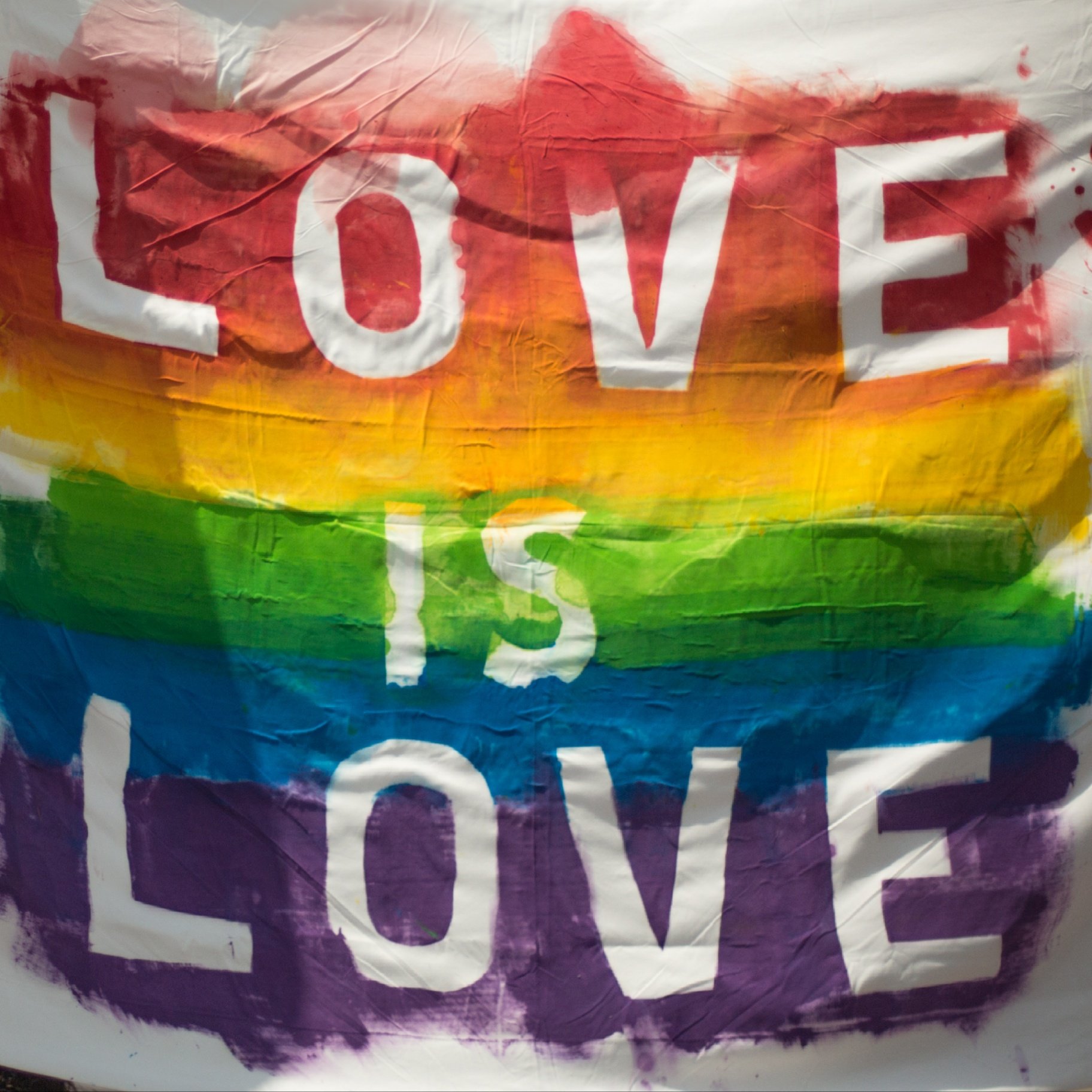 Love is Love rainbow pride flag representing LGBTQ+ affirmation and inclusivity