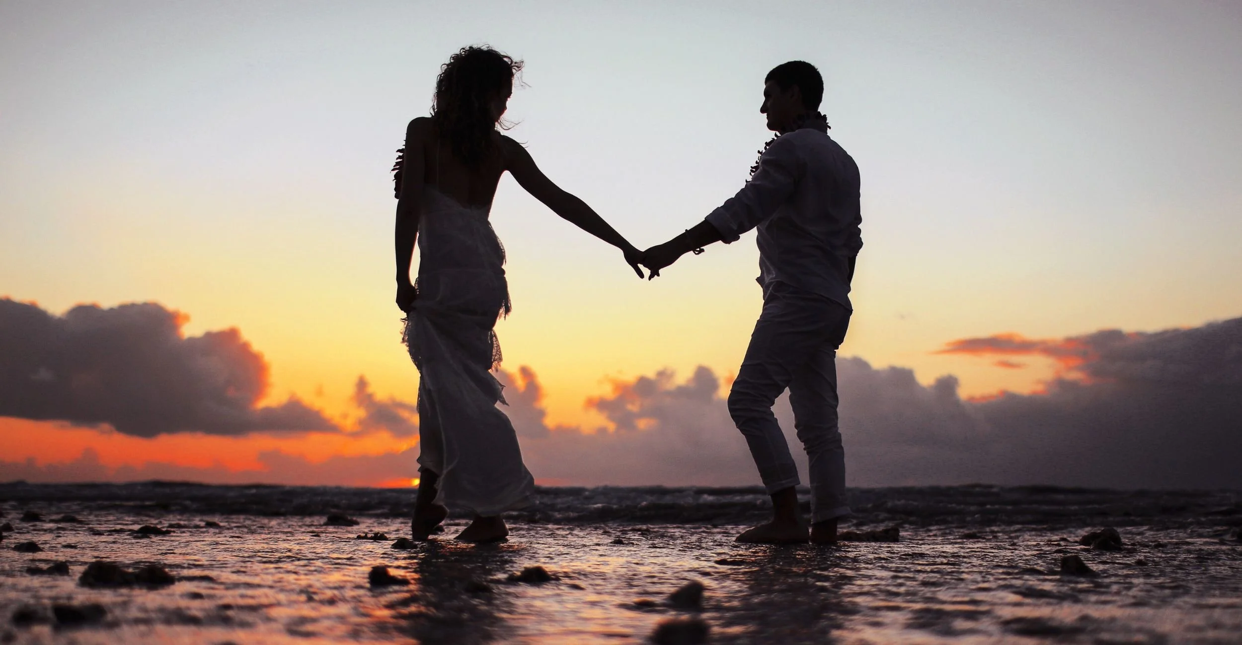 couple-holding-hands-at-sunset-relationship-therapy.jpg