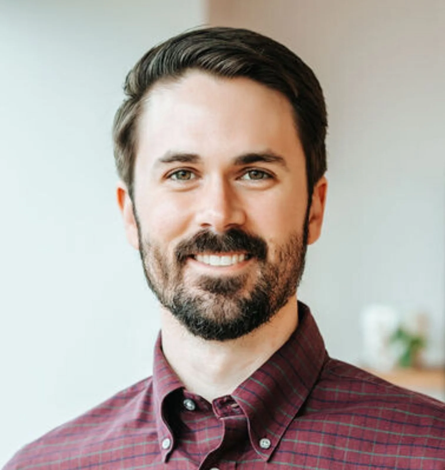 Picture of a smiling anxiety therapist in Richmond VA with neat brown hair, a beard, and a button down shirt.