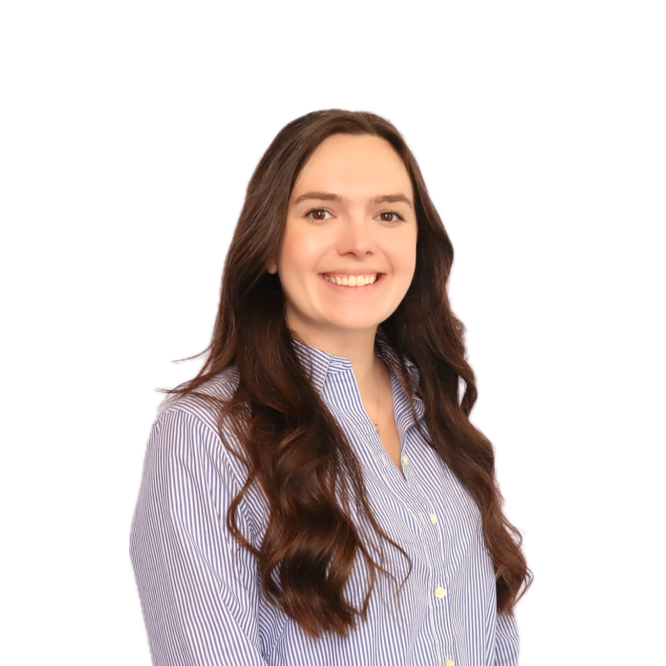A woman with long brown wavy hair smiling, wearing a blue and white striped button-up shirt, against a plain background.