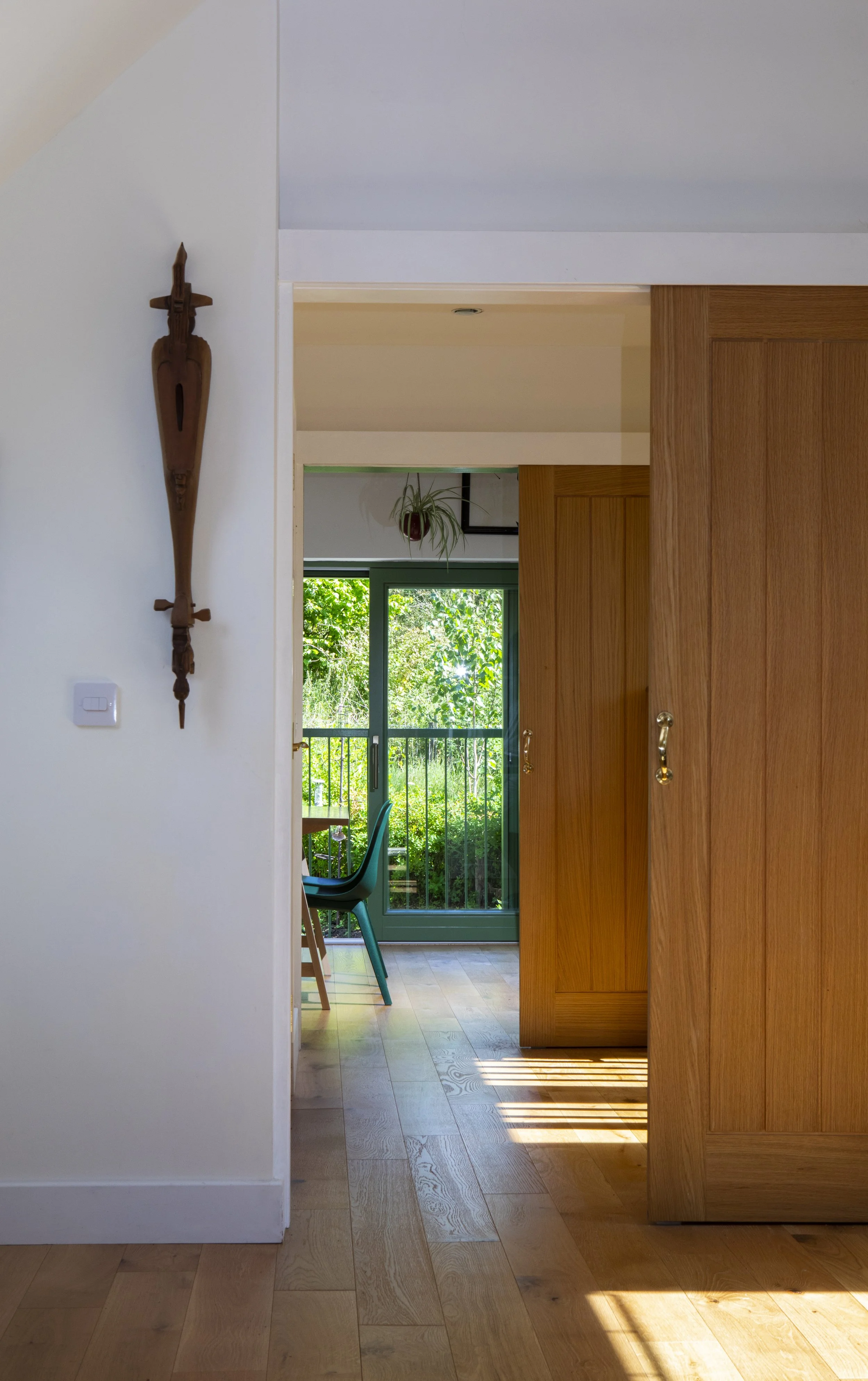 Tully Beg House, a view through the house's sliding wooden doors to the woodland beyond.