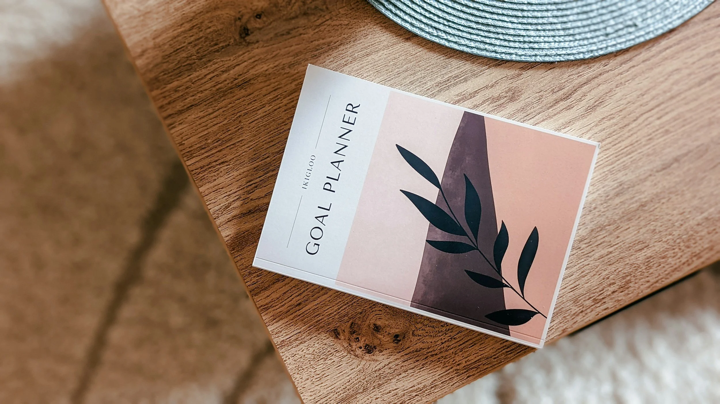 A goal planner magazine lying on a table.