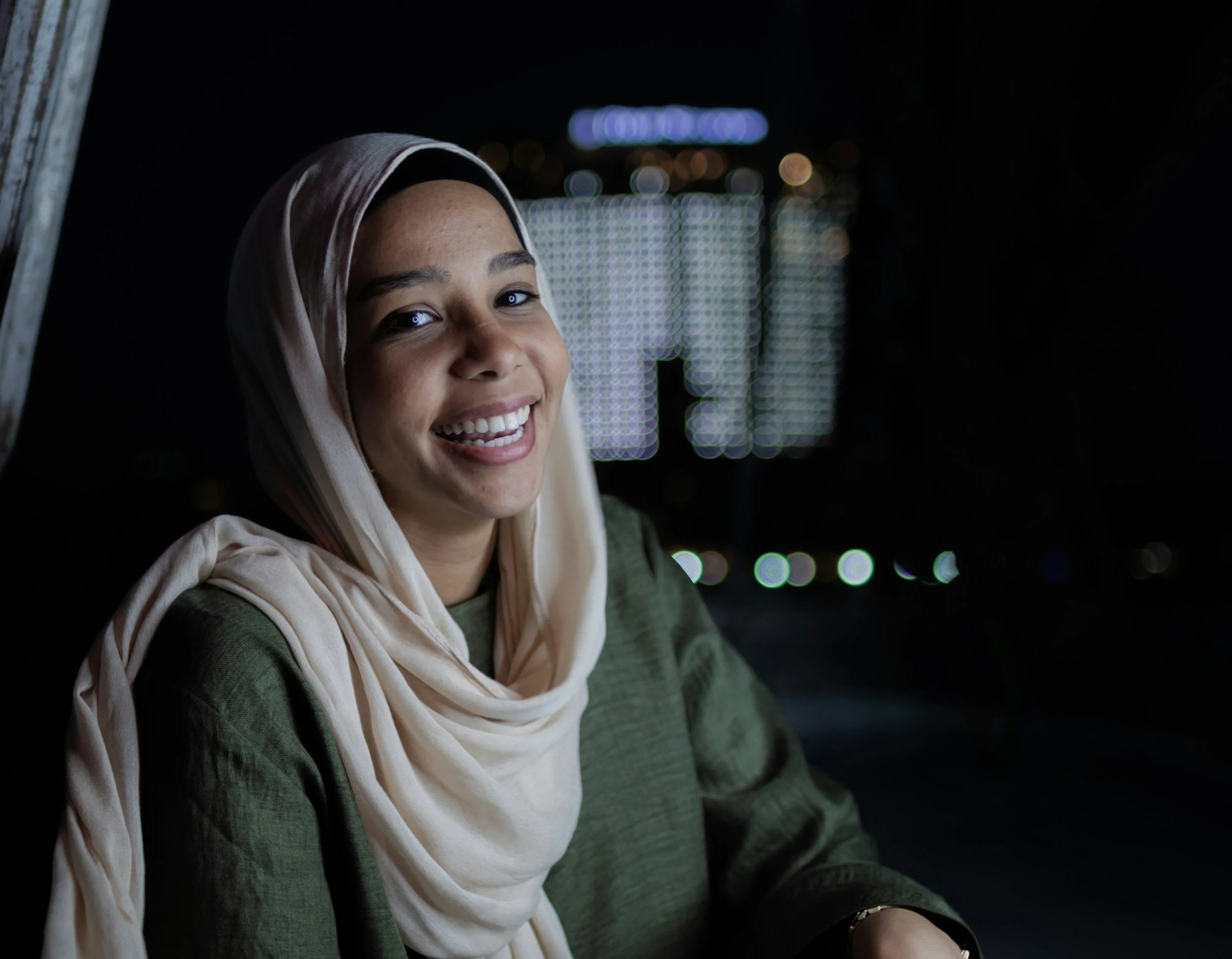A Muslim woman in a hijab smiling