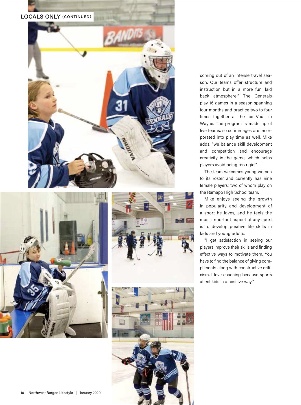 Ice hockey players, including a young player and a goalkeeper, on the ice rink during practice, with one player sitting in the bench area, in a sports facility decorated with various flags.