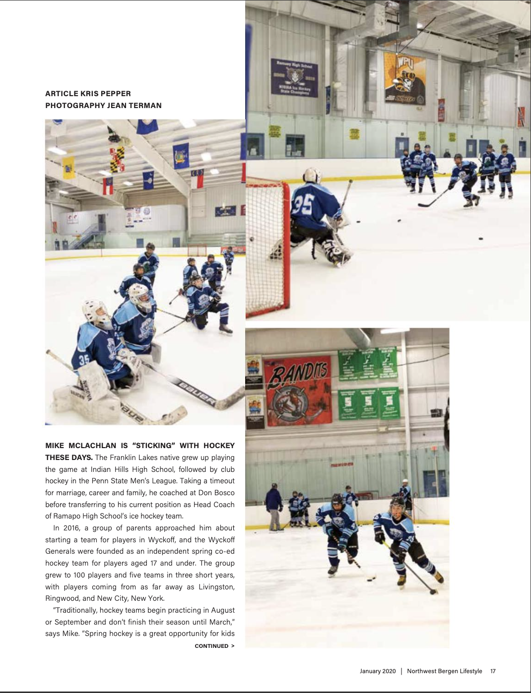 Youth ice hockey team practice at an indoor rink, with players in blue jerseys, and flags hanging from the ceiling.