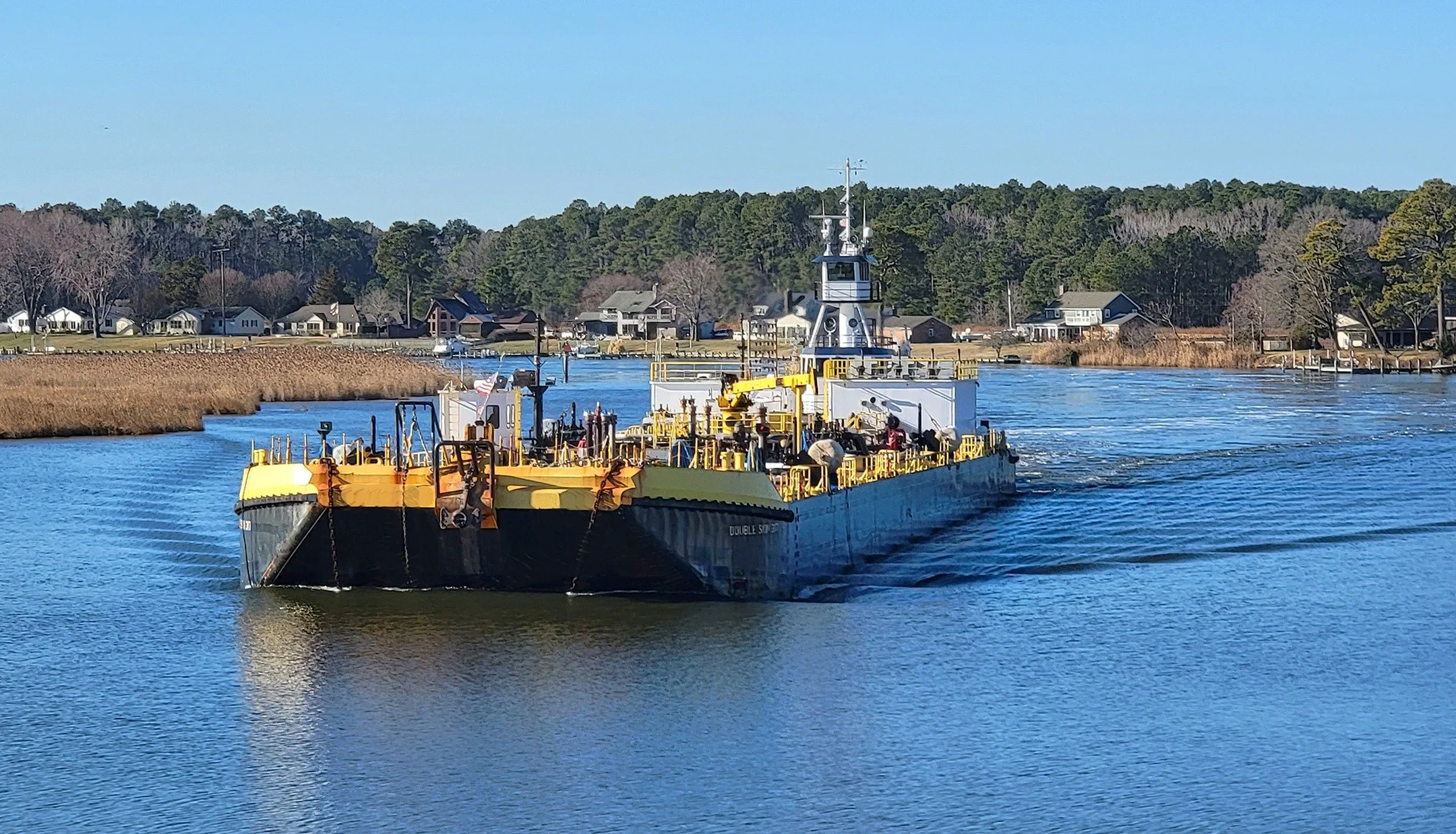 The Vane Brothers barge Double Skin 317 is pushed up the Wicomico River by the tug Cape Henry last February. [Photo by Kenny Marshall] #TheVaneBrothersCompany #Tugboat #Barge #CapeHenry #WicomicoRiver