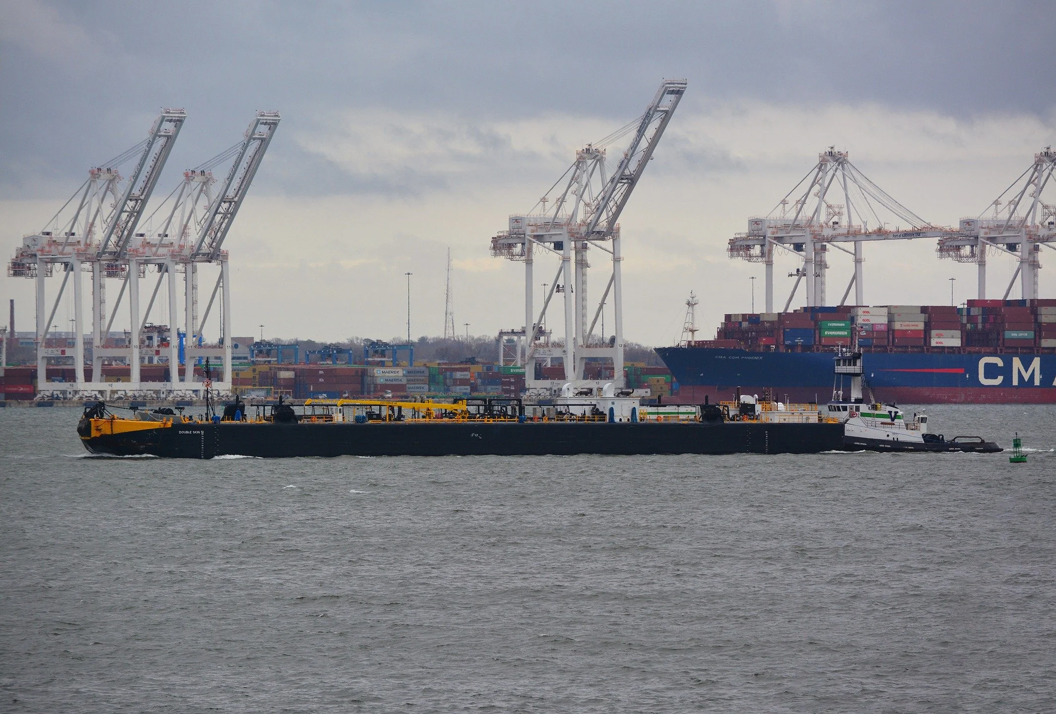 Vane Brothers' 4,200-hp tug MAGOTHY brings the barge Double Skin 51 into the Port of Baltimore this afternoon as storm clouds gather overhead. #TheVaneBrothersCompany #Tugboat #Barge #Magothy #PortofBaltimore