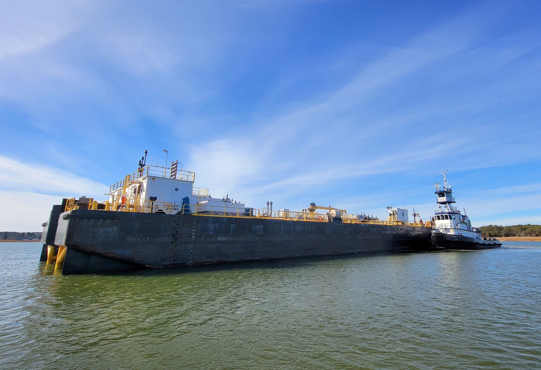The Vane Brothers 3,000-hp tug CAPE HENRY maneuvers around the barge Double Skin 317 in order to settle into push mode and then head out the Wicomico River on the Eastern Shore of Maryland. [Photo by Kenny Marshall] #TheVaneBrothersCompany #Tugboat #