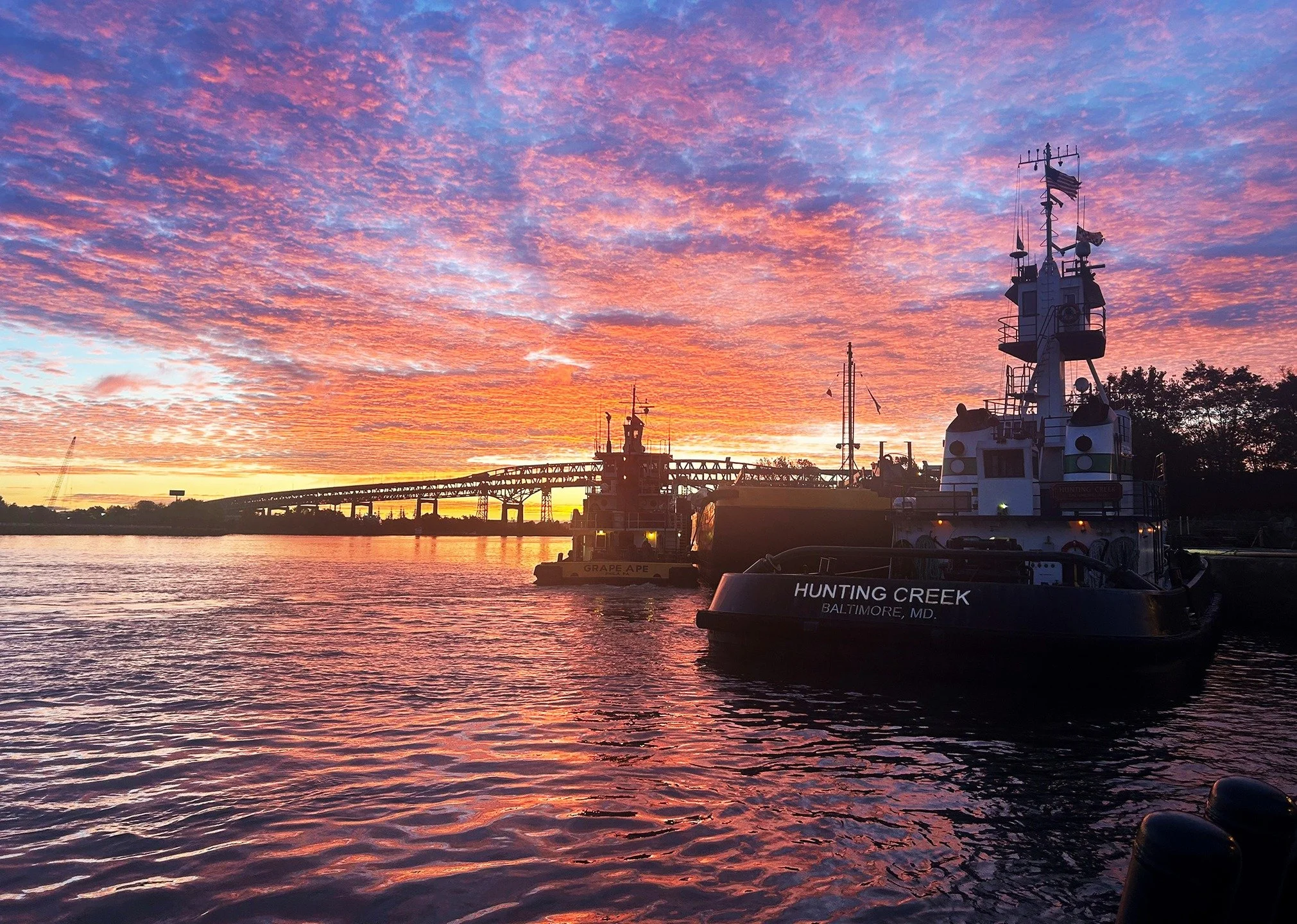 Sunrise at Philly City Dock, with the 3,000-hp Vane Brothers tug HUNTING CREEK in the foreground. [Photo by Lewis Wheatley] #TheVaneBrothersCompany #Tugboat #HuntingCreek