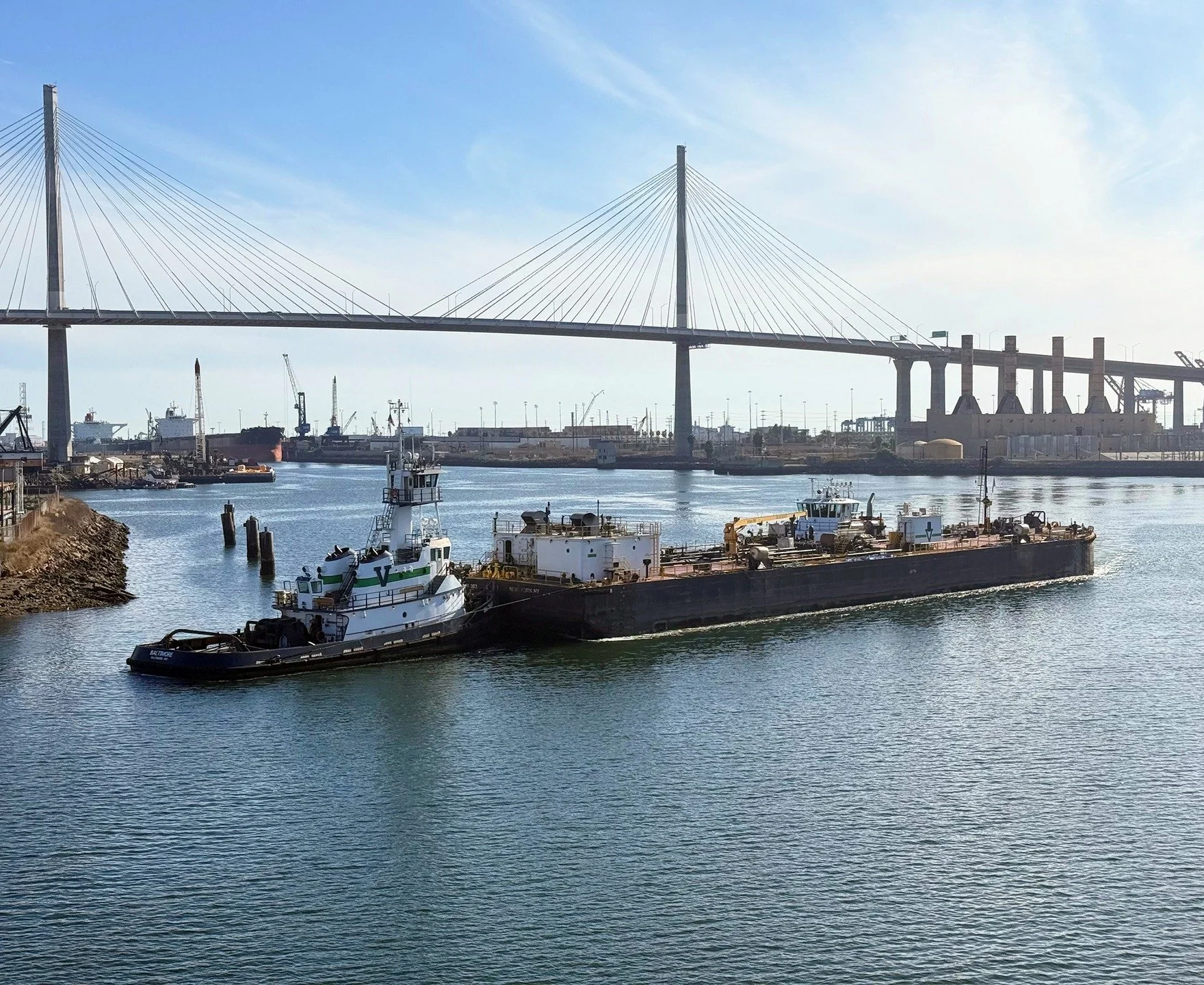 The Vane Brothers tug BALTIMORE and barge Double Skin 303 pass in the vicinity of the Long Beach International Gateway Bridge, CA. [Photo by Hope Jeffries] #TheVaneBrothersCompany #Tugboat #Barge #Baltimore #InternationalGateway