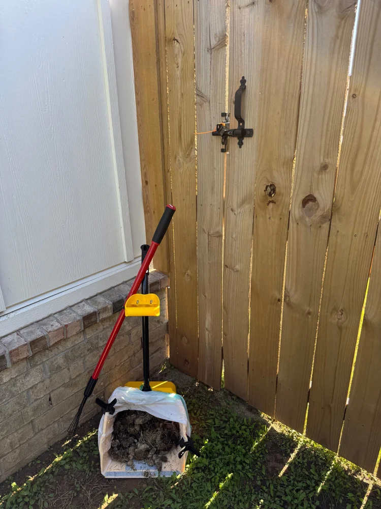 Gate closed and secured with an orange zip tie after service.