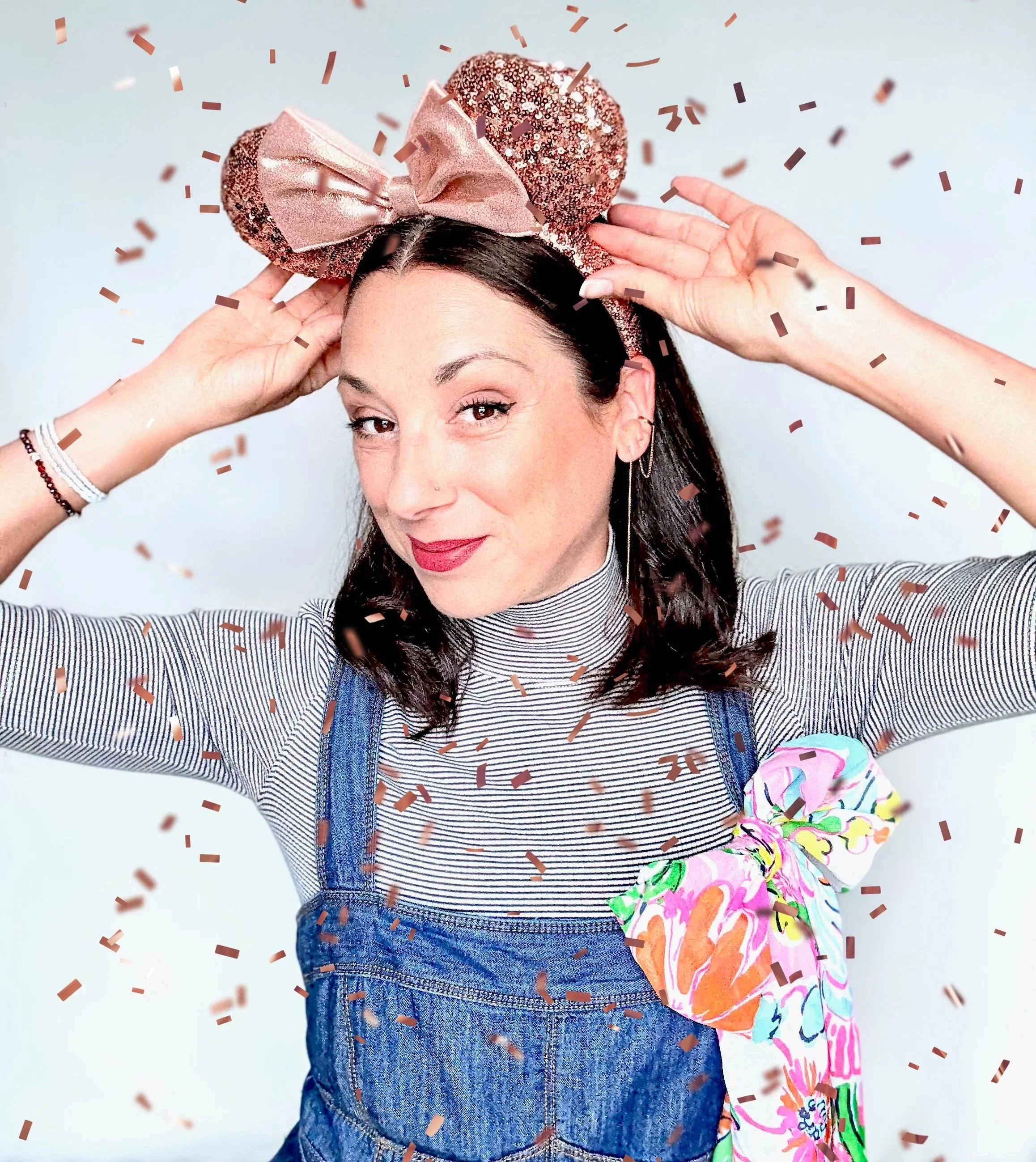 Roberta wearing rose gold Minnie Mouse ears celebrating that she is a successful Travel Advisor!