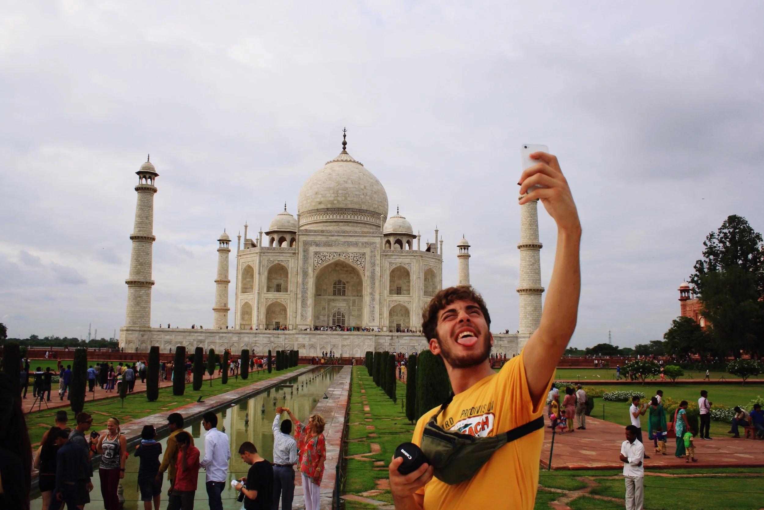 man-taking-selfie-standing-against-taj-mahal.jpg