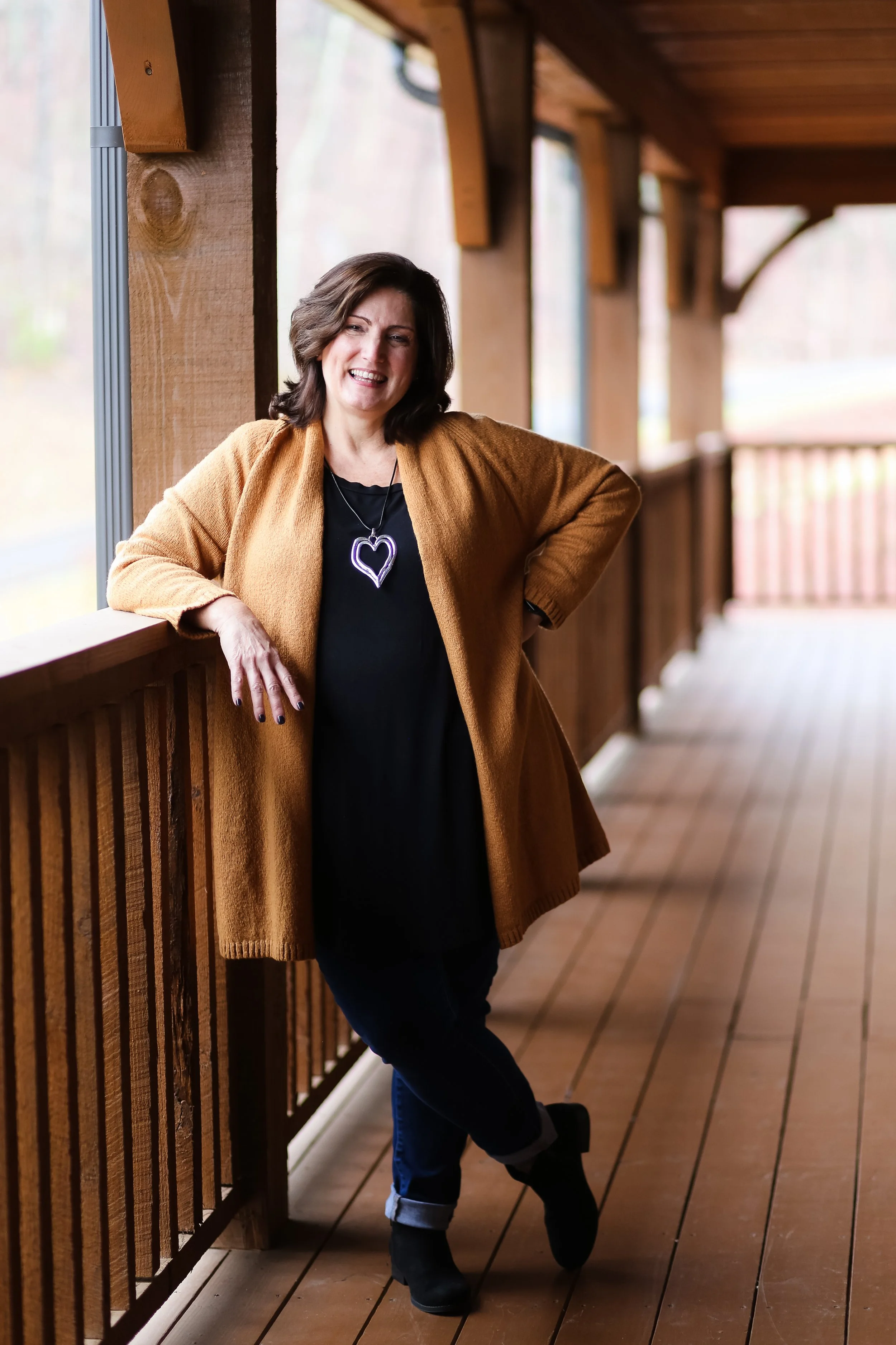 Nance Squires smiles while leaning against a railing