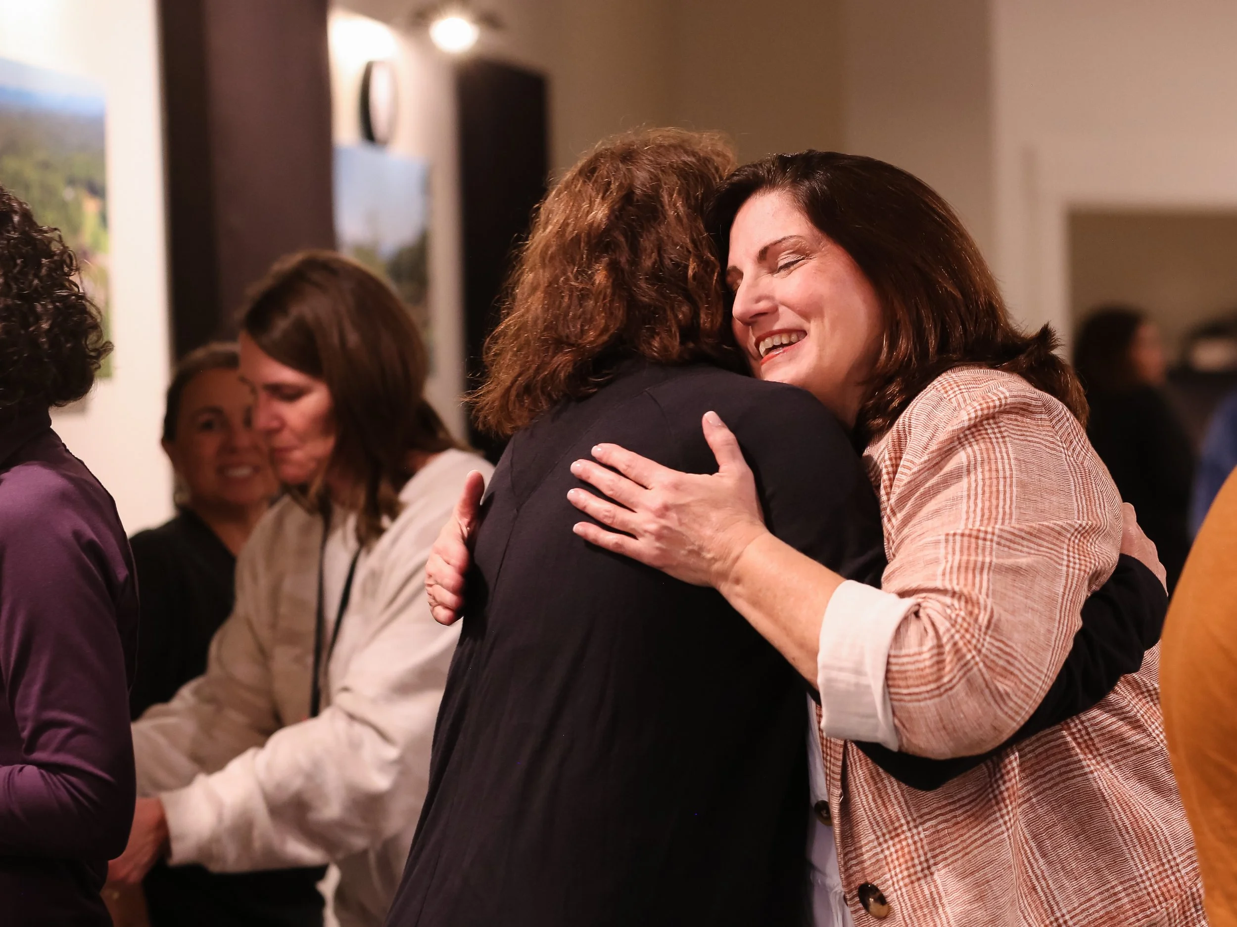 Nancy Squires hugs a retreat attendee 