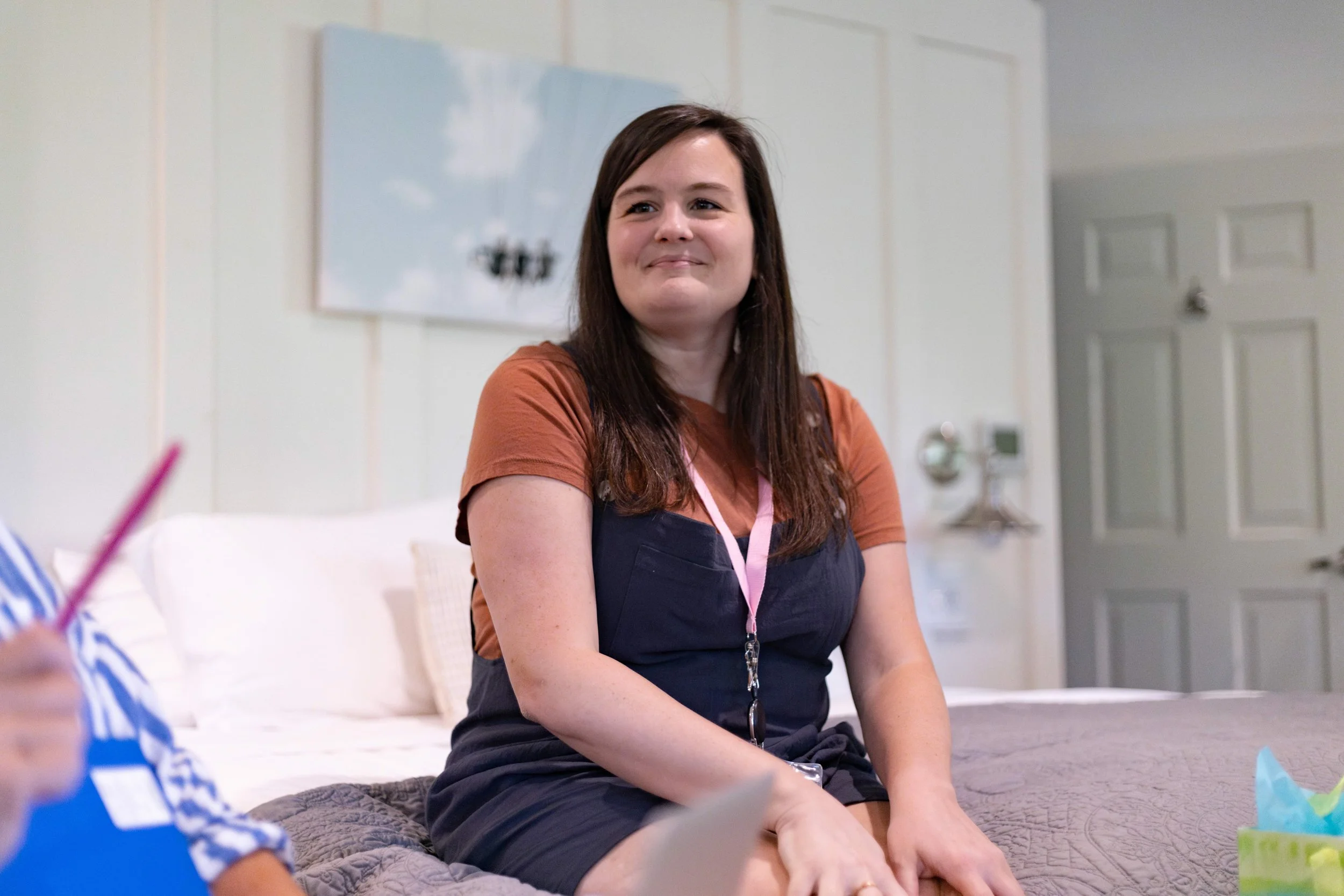 A woman smiles during Small Group time