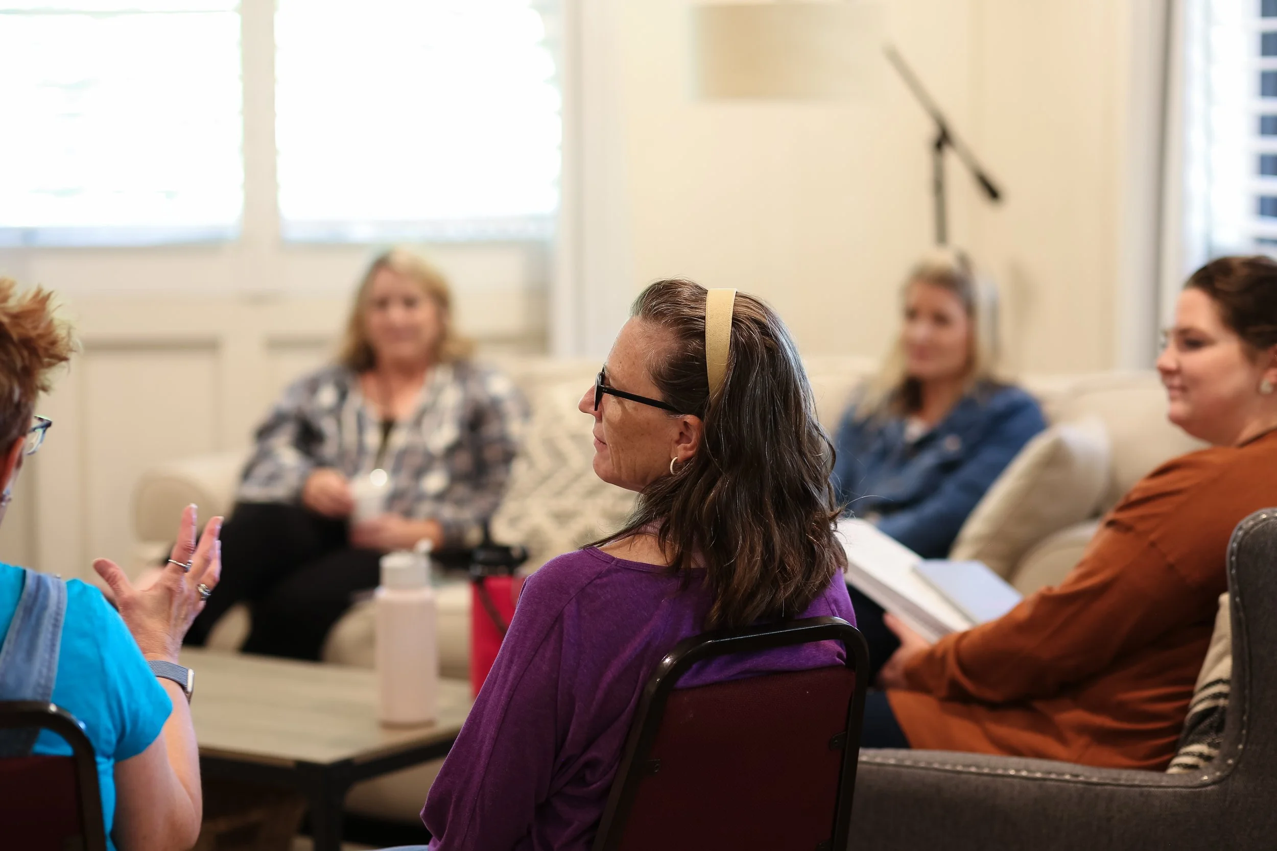 A group of women sit and talk during Small Group time at a Just Be Held retreat