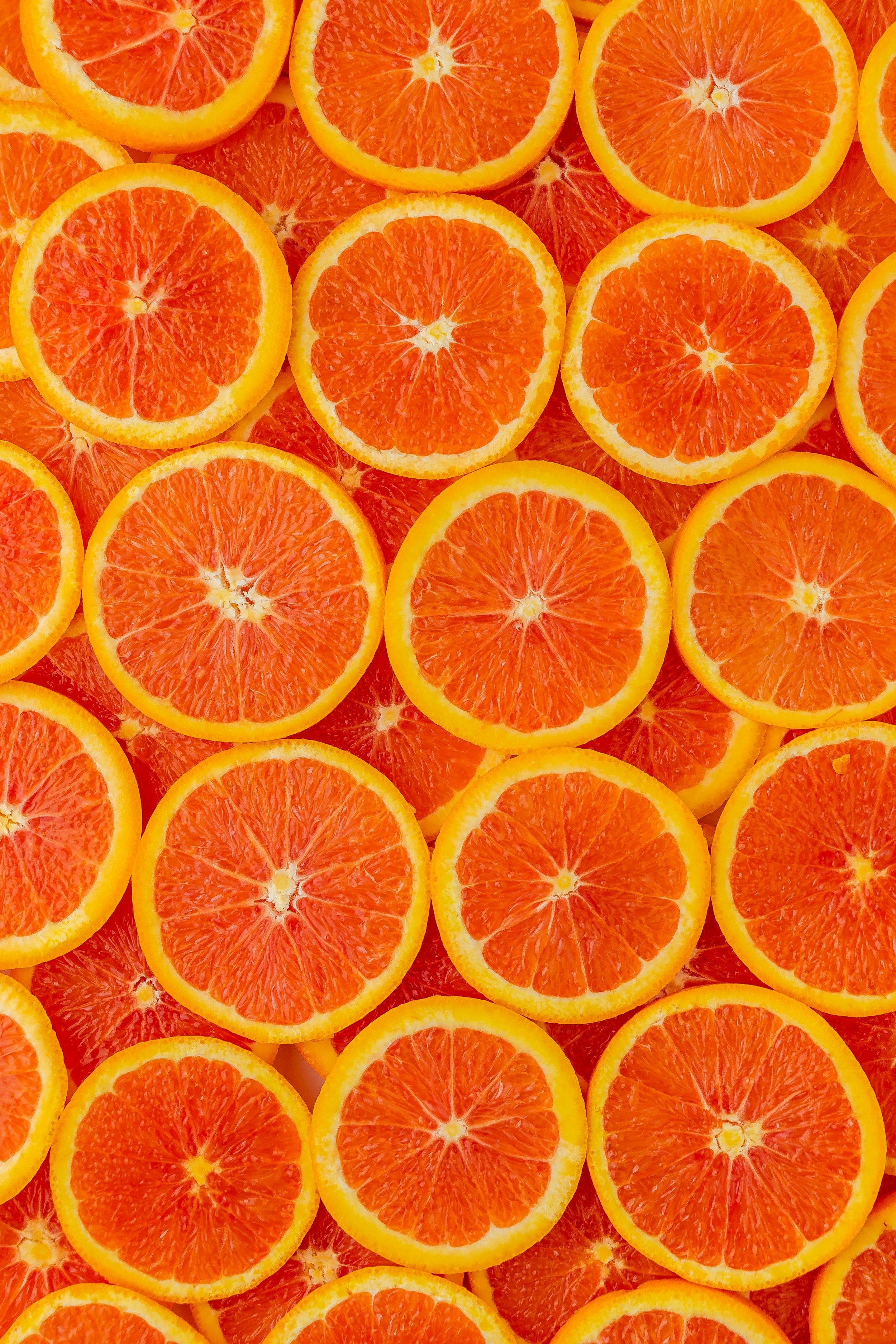 Close-up of sliced oranges arranged closely together.