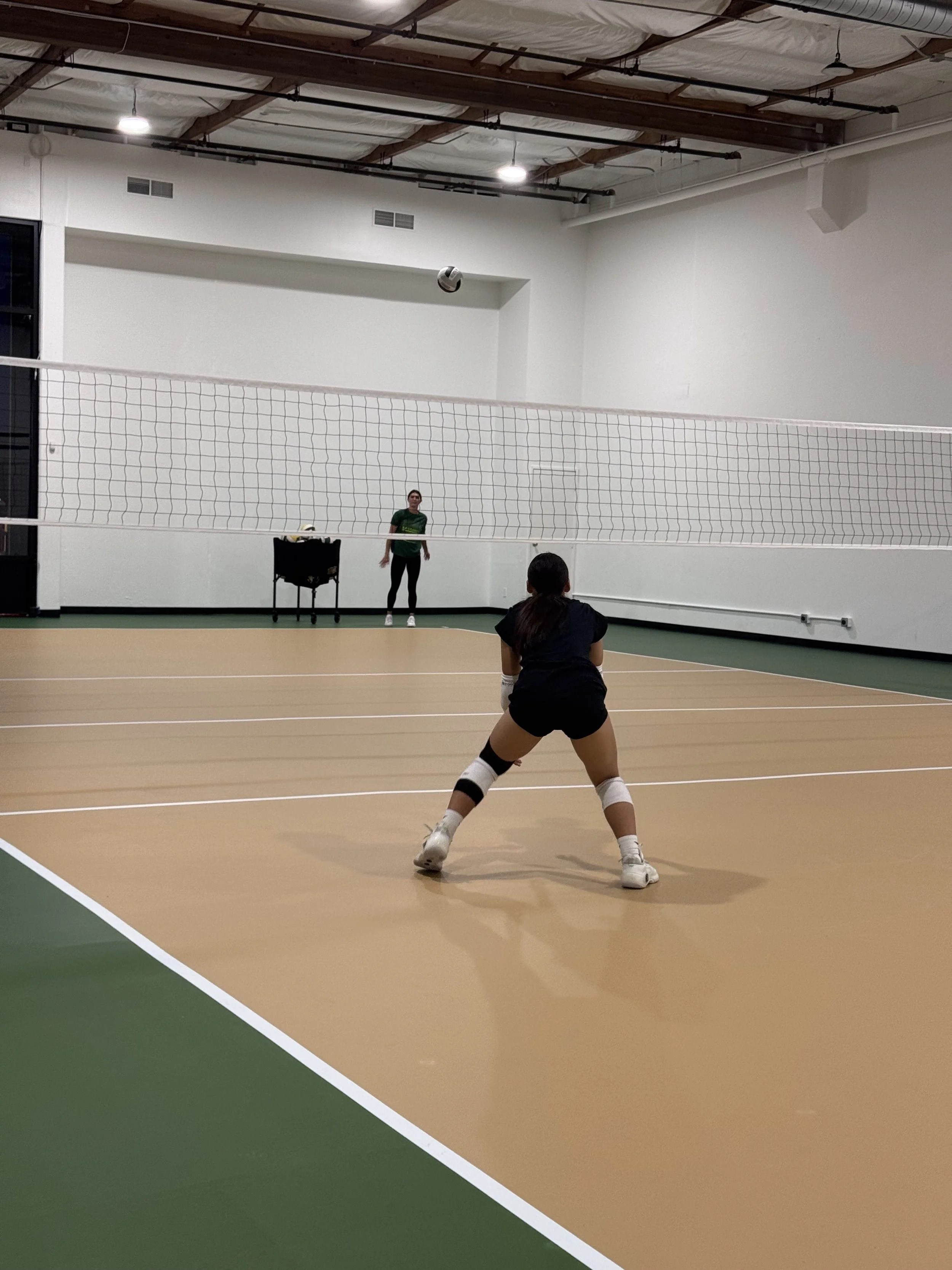 Teenage girl working hard during volleyball private lessons. Burning calories and will need to refule.