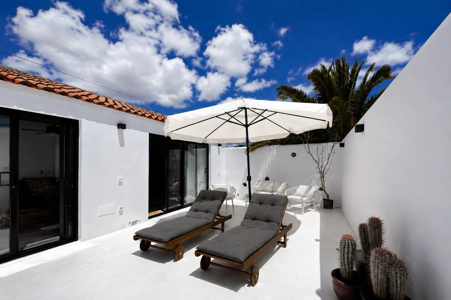 Private sun terrace with loungers under the Lanzarote sky.