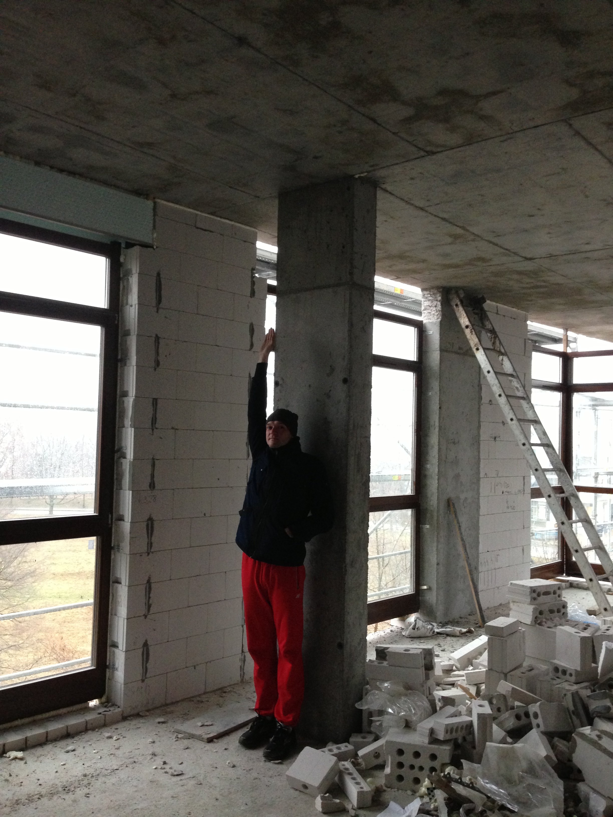 Concrete structural column inside our apartment during renovation in Warsaw.