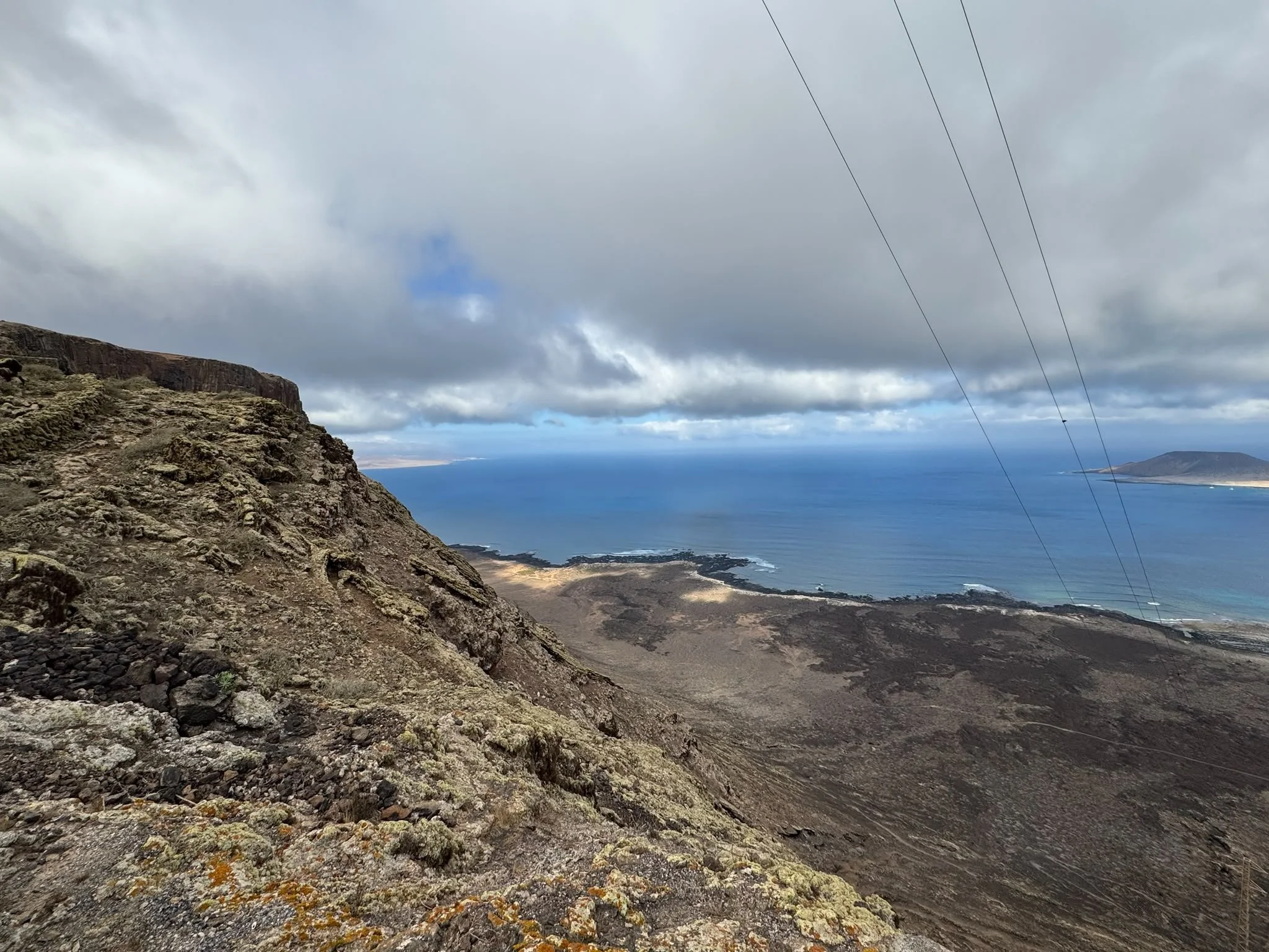Volcanic landscape along Camino de los Gracioseros overlooking El Río and La Graciosa